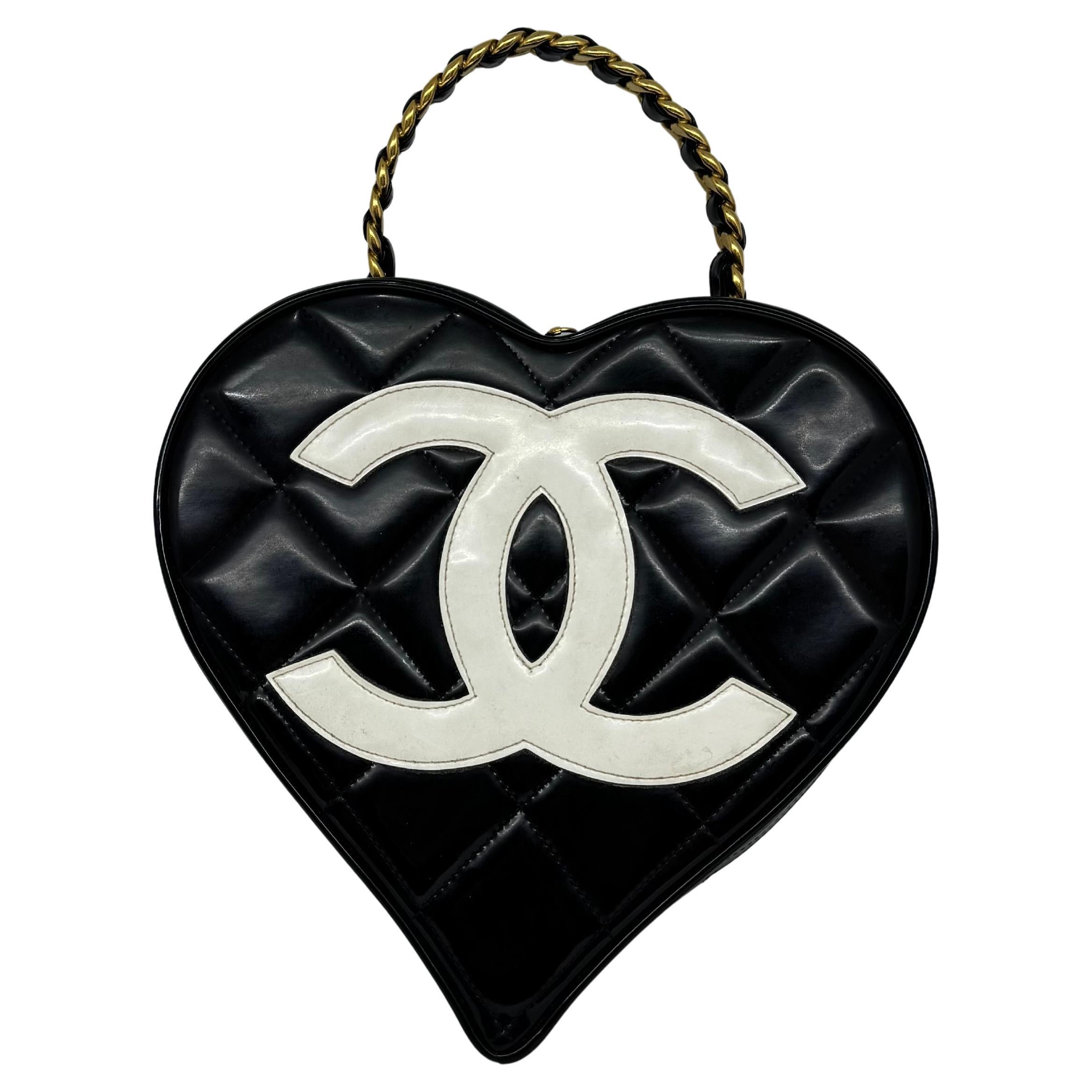 Collector’s item chanel vintage heart vanity in black patent with gold hardware. Original condition. No touch ups or recoloring. Slight cloudiness to the patent surface due to storage and wear. Minor scratches on the lambskin lining. The handle is