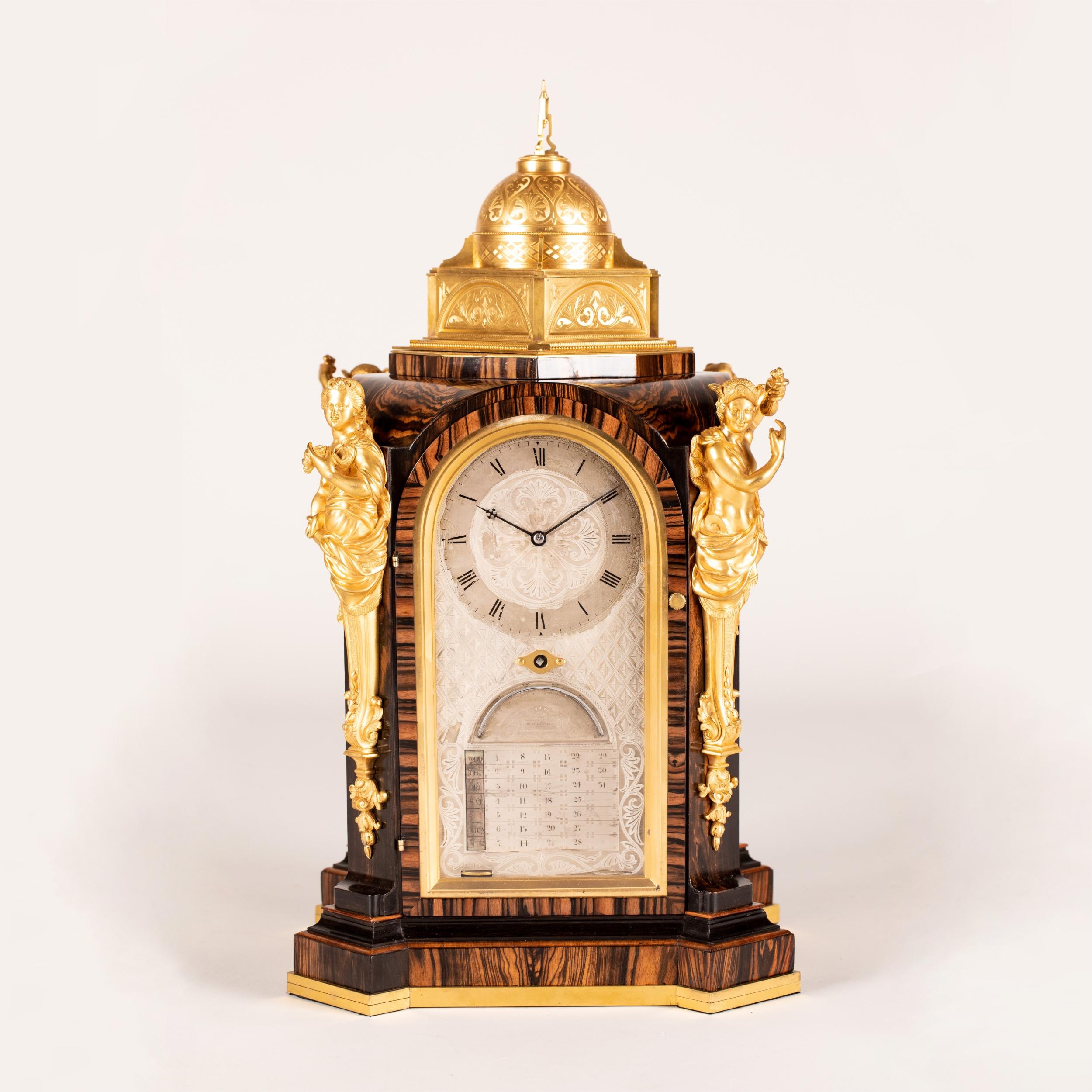 A Superb Coromandel-Veneered Mantle Clock

The case constructed of very well-figured Coromandel giving the maximum amount of decorative effect, with gilt bronze accents; the plinth base of rectangular form, with everted stepped corners, and