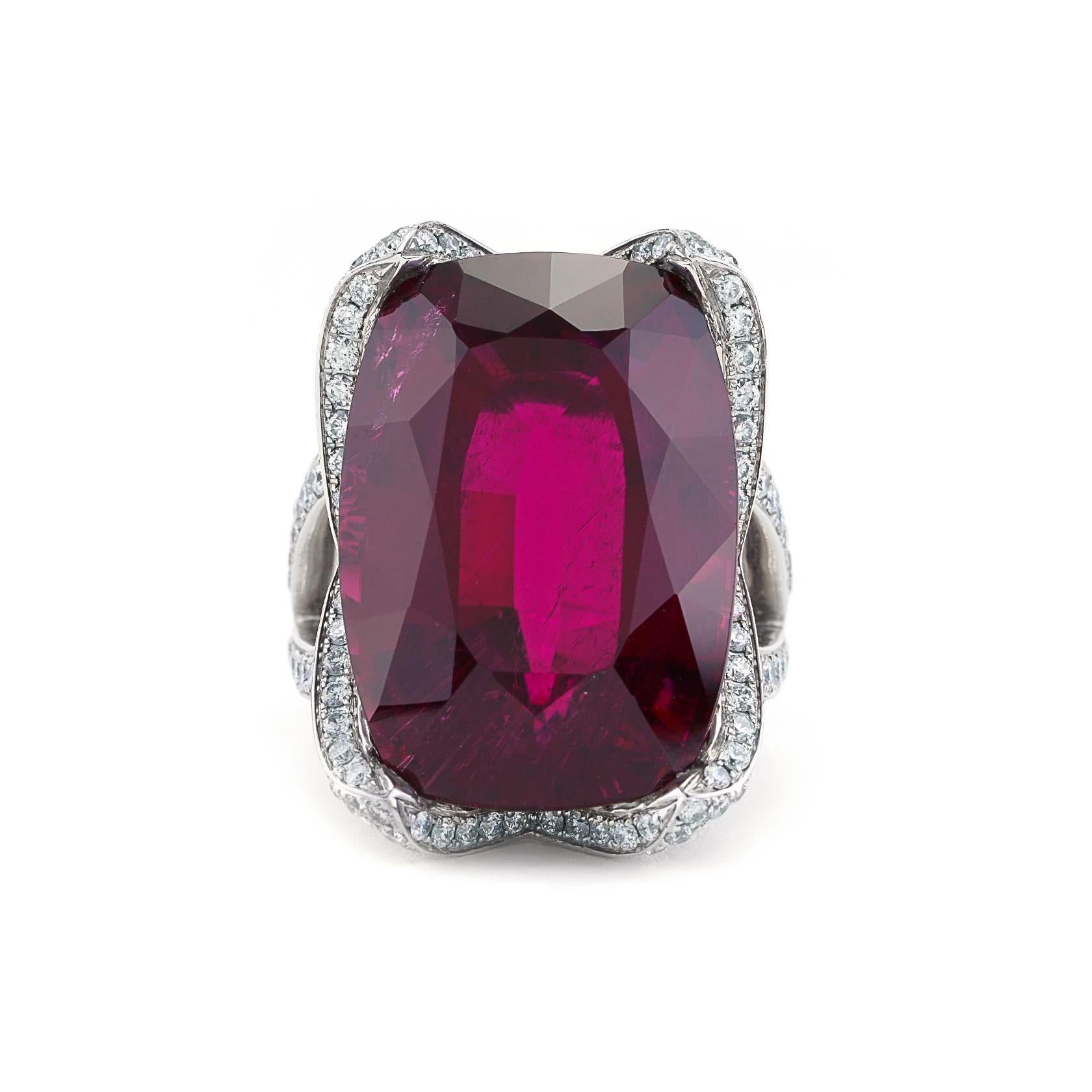 Introducing a breathtaking masterpiece of elegance, this exquisite ring features a very rare 38.21 carat rubellite as its centerpiece. Sourced from the renowned Cruzeiro Mine in Brazil, this unique tourmaline exhibits an intense red hue reminiscent