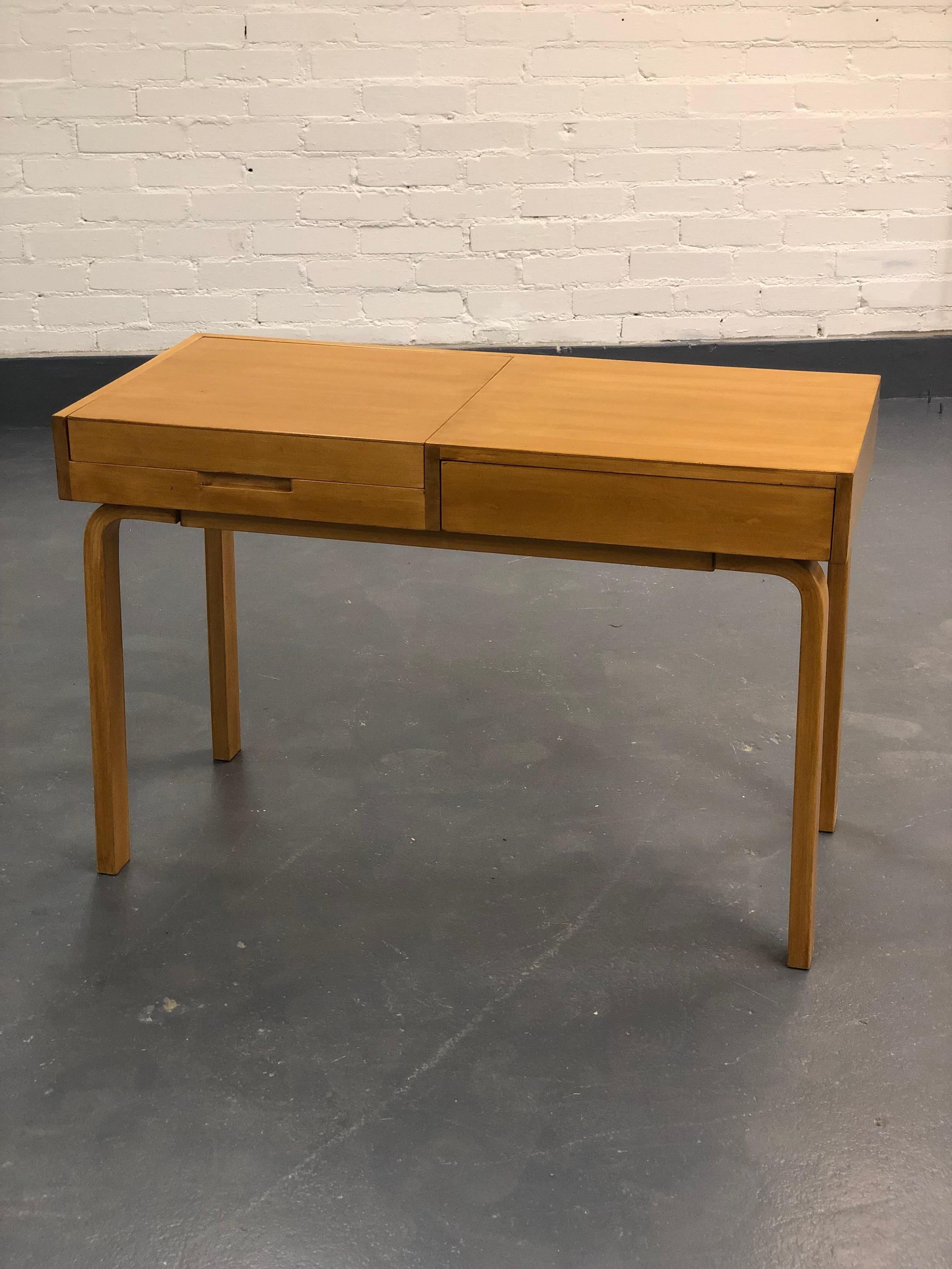 Over half a century later, from its original days of manufacturing, this dressing table designed by Alvar Aalto and made by Artek, is extremely hard to come by anymore. This particular piece comes in original condition with all of the original