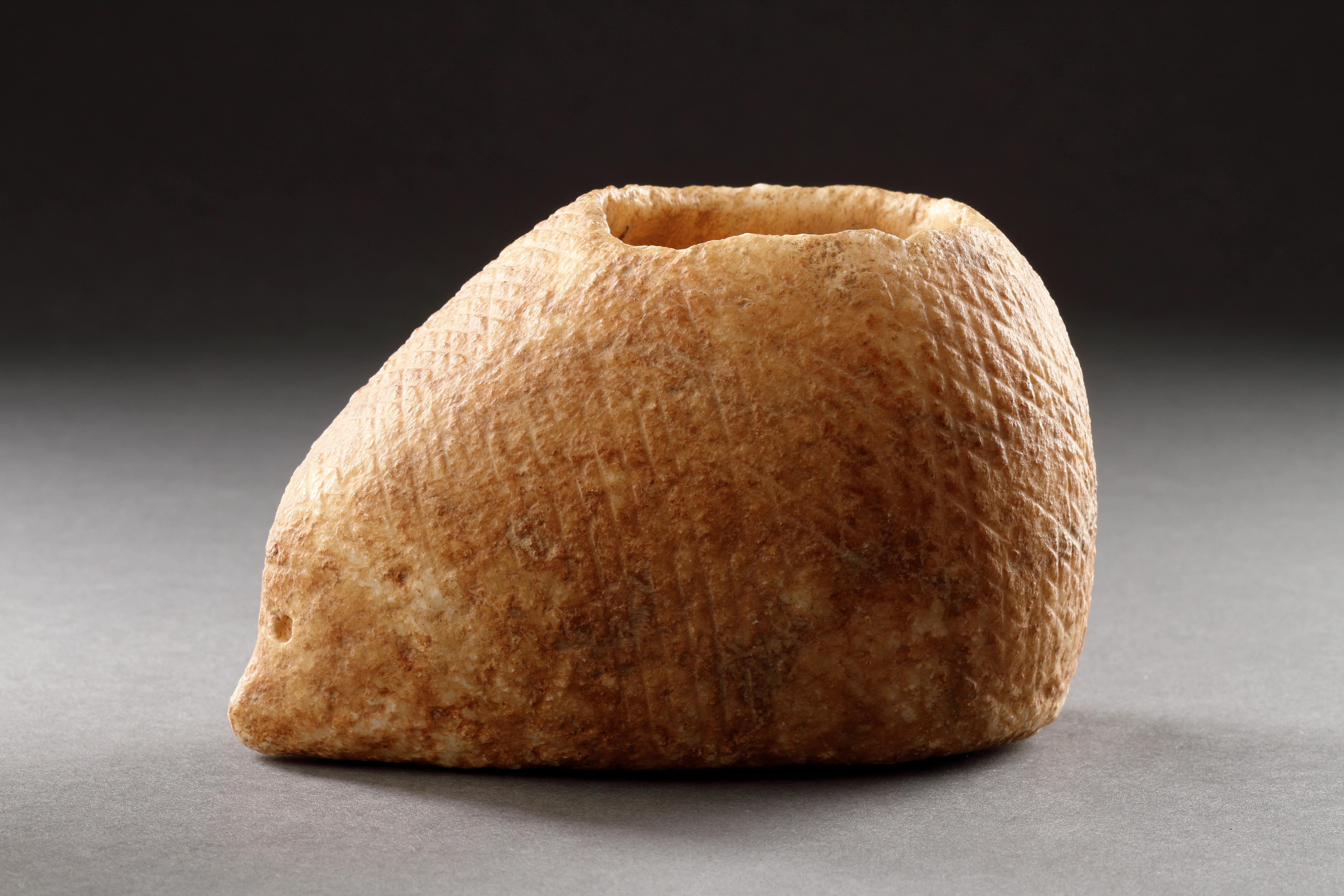 A Very Rare and Early Carved Vessel in the Form of a Hedgehog 
Alabaster
Near Eastern 
3rd Millenium BC 

SIZE: 9.5cm high, 9.5cm wide, 15.5cm deep - 3¾ ins high, 3¾ ins wide, 6 ins deep 

The body with ‘cross hatching’ to suggest spines. The small