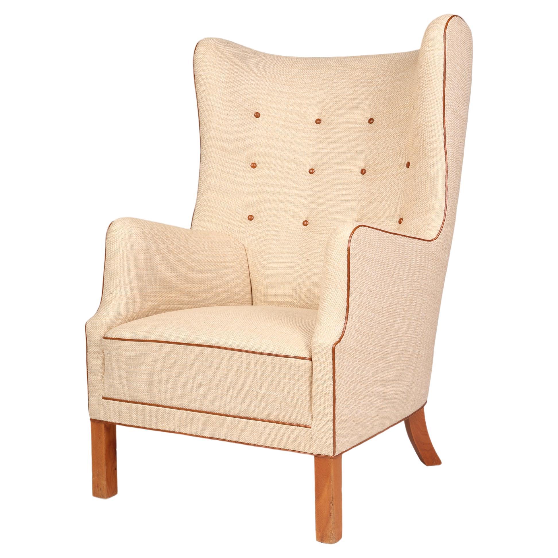 Danish wingback armchair with off-white canvas, Niger leather details, elm legs For Sale