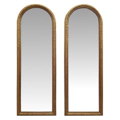 Rarissima e raffinata coppia di specchi ad arco in legno dorato del XIX secolo