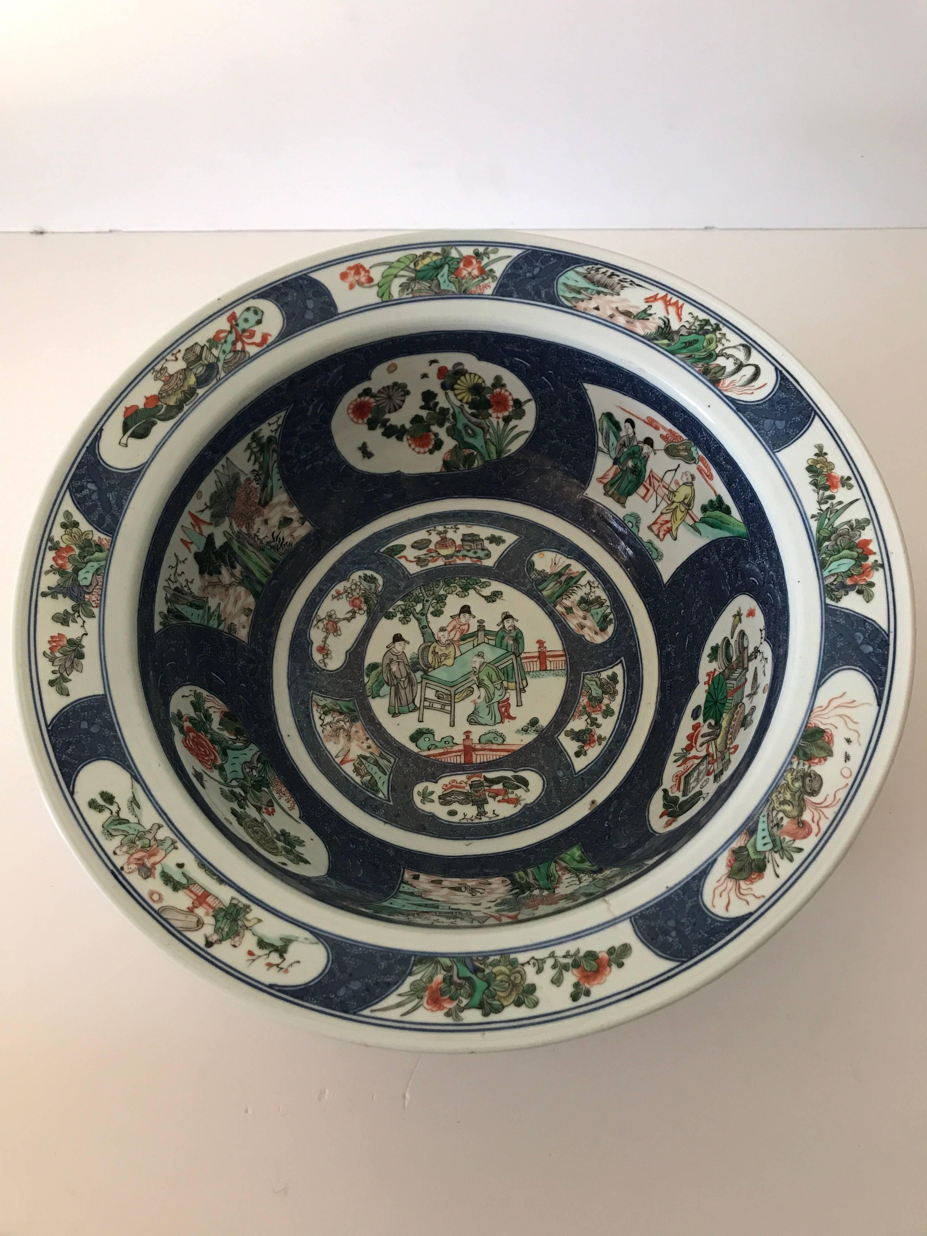 Very rare and large Chinese famille verte bowl, late 19th century.
A very rare bowl in famille verte depicting six cartousches on the inner side and eight cartousches on the rim all depicting traditional Chinese sceneries and figures. Peonies,