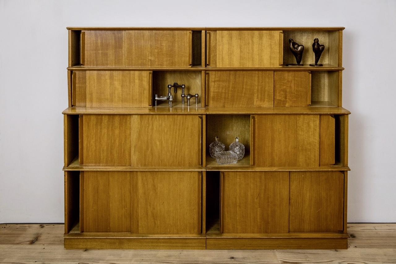 Extremely special modular shelf in the style of Charlotte Perriand in beautiful patinated oak veneer. Massive and conical tapered handles and horizontal strips of massive oak. Unknown markings in the back. The shelf has an elegant closed or lively
