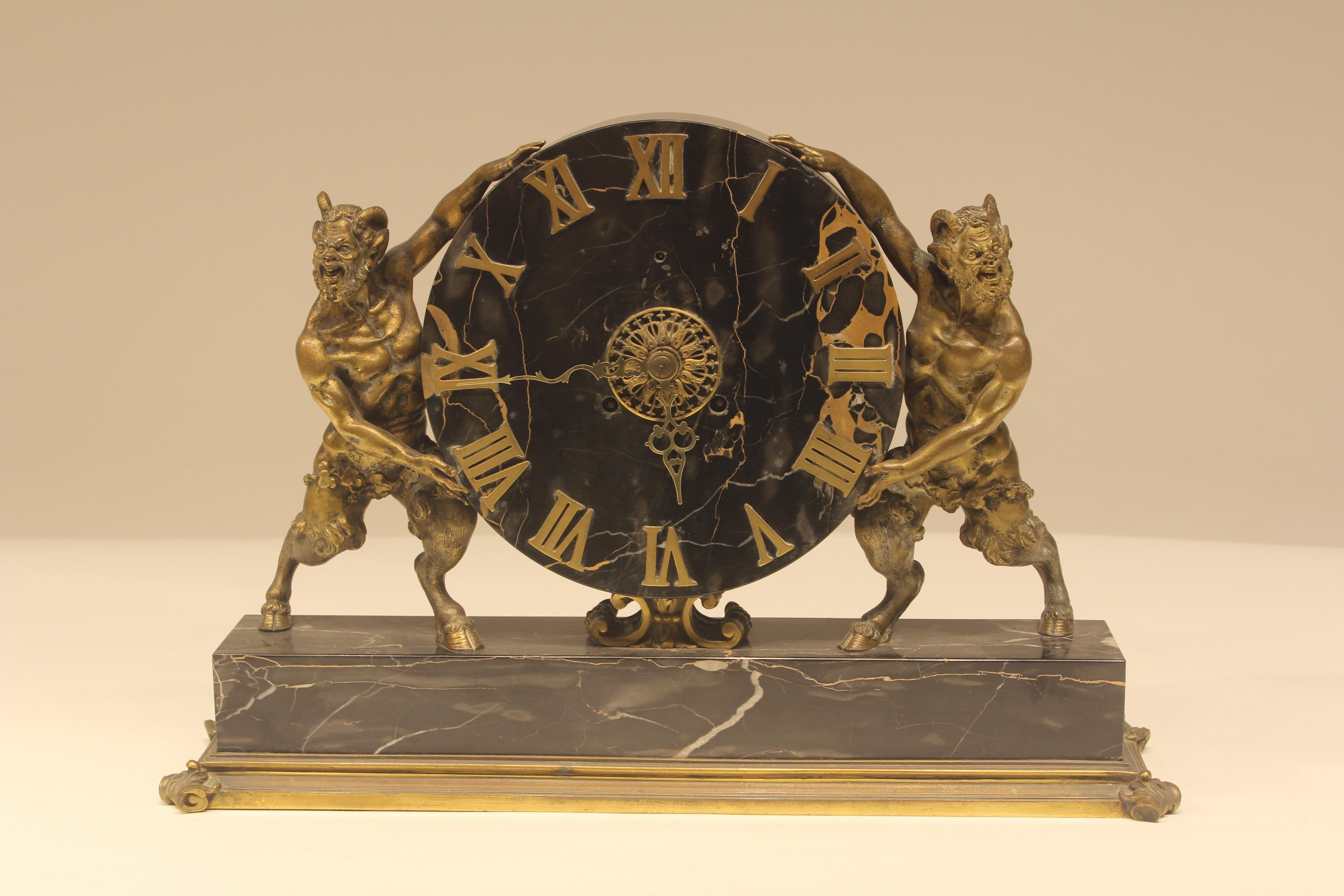 Very rare and unusual signed E.F. Caldwell mantel clock with black marble and bronze base. Figural gestures holding clock face. All original signed on back panel.