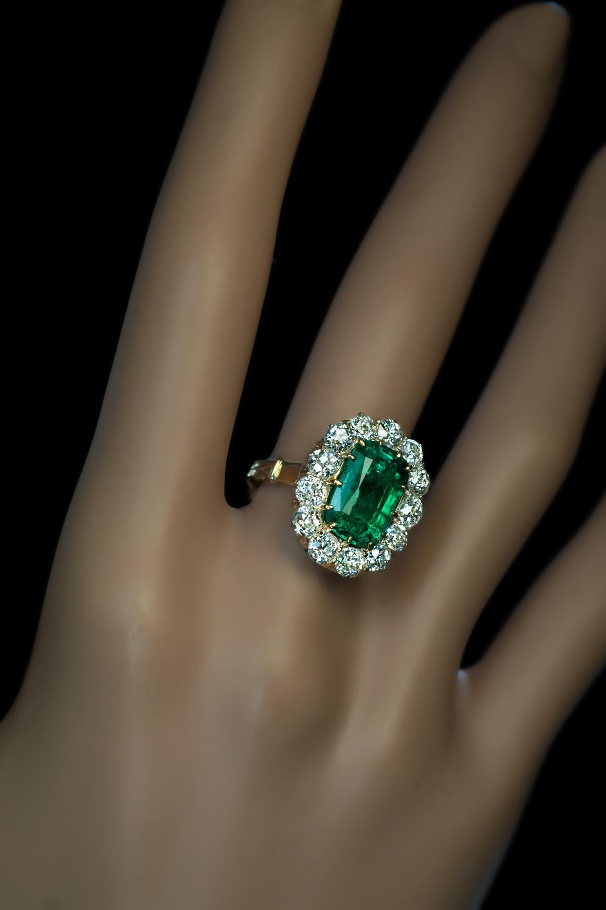 This antique Russian ring dated ‘1871’, features a very rare Russian (the Ural Mountains) lush bluish green emerald (3.24 Ct) surrounded by bright white old mine cut diamonds.

The ring is crafted in 14K yellow gold. The diamonds are set in silver
