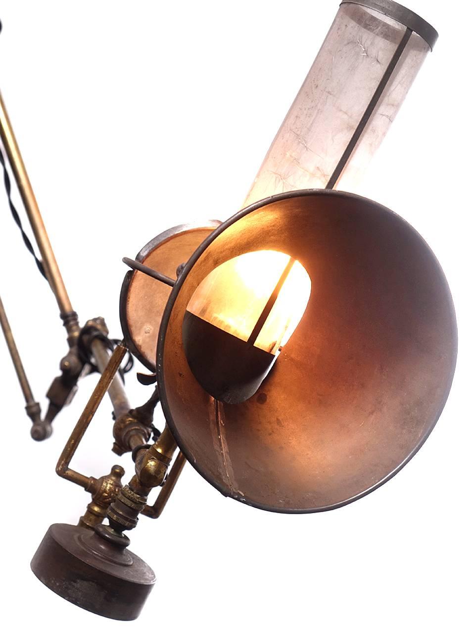 This lamp is so unique and very delicate. The original mica chimney and funnel shade is still intact. I'm guessing that this was a medical or scientific lamp from the mid-late 1800s. Sometimes this type of lamp was used to a brighten the view on a