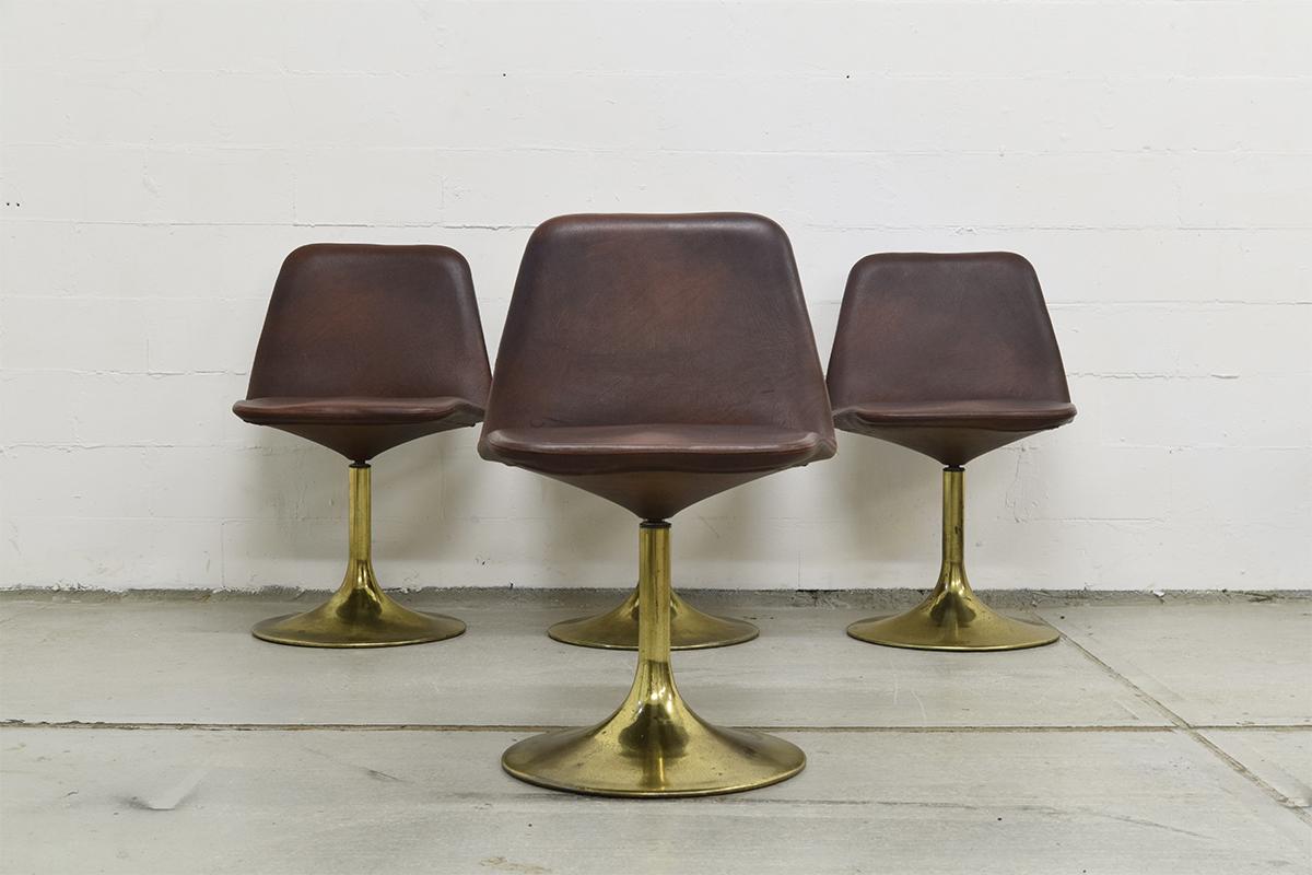 Very rare brass and with original faux leather Lounge set containing of 4 swivel chairs and a small table. The swivel chairs are very comfortable. They are designed by Börje Johansson and produced by Johansson Design in Markaryd, Sweden in the