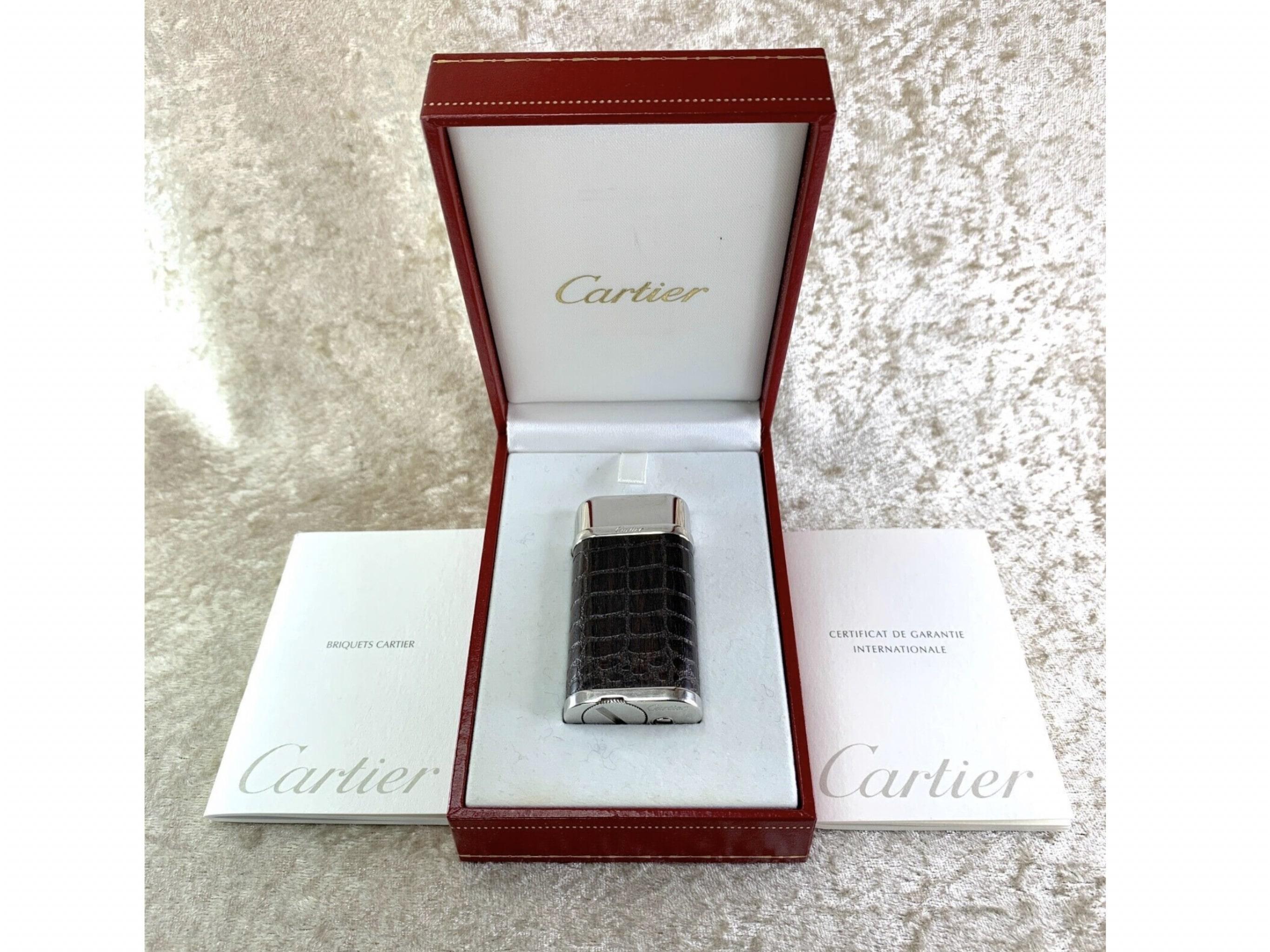 Rare Cartier Lighter Crocodile Skin Pattern Engraved 
In rare condition 
This Cartier lighter comes with original case and papers 
Authentic Cartier Gas Lighter 
Excellent looking working condition
The size 60 x 30 x 12 mm
Color - Silver
