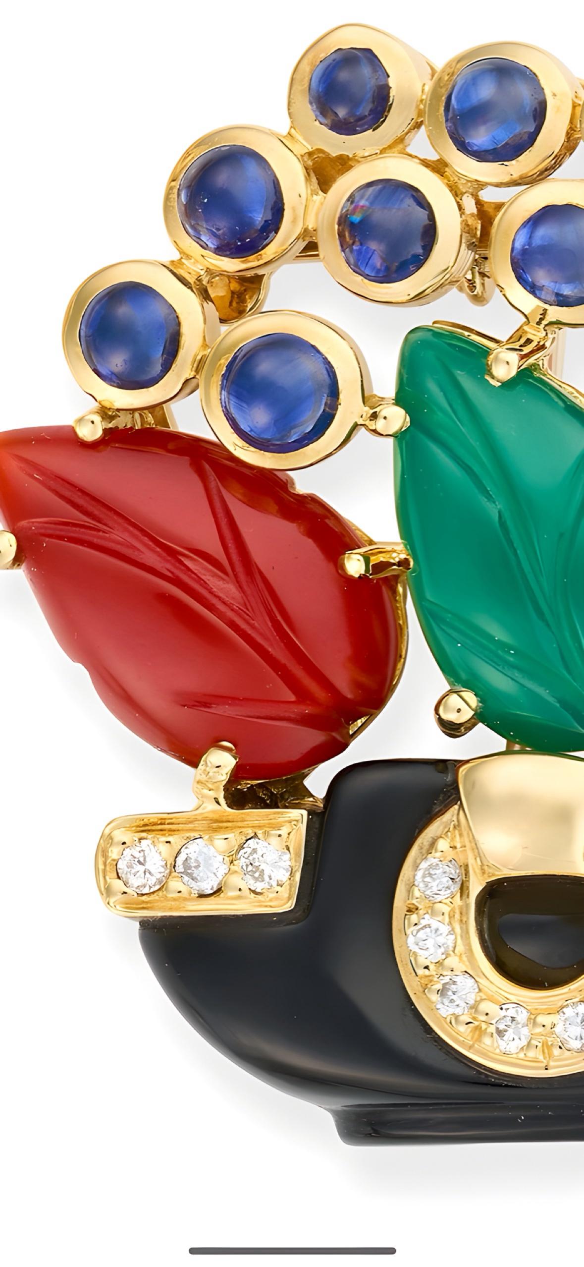 Very Rare example of a Cartier Giardinetto Brooch 1989

18ct yellow gold, comprising a polished onyx pot set with round brilliant cut diamonds, the flowering plant set with carved chrysoprase and carnelian leaves, round cabochon sapphires and