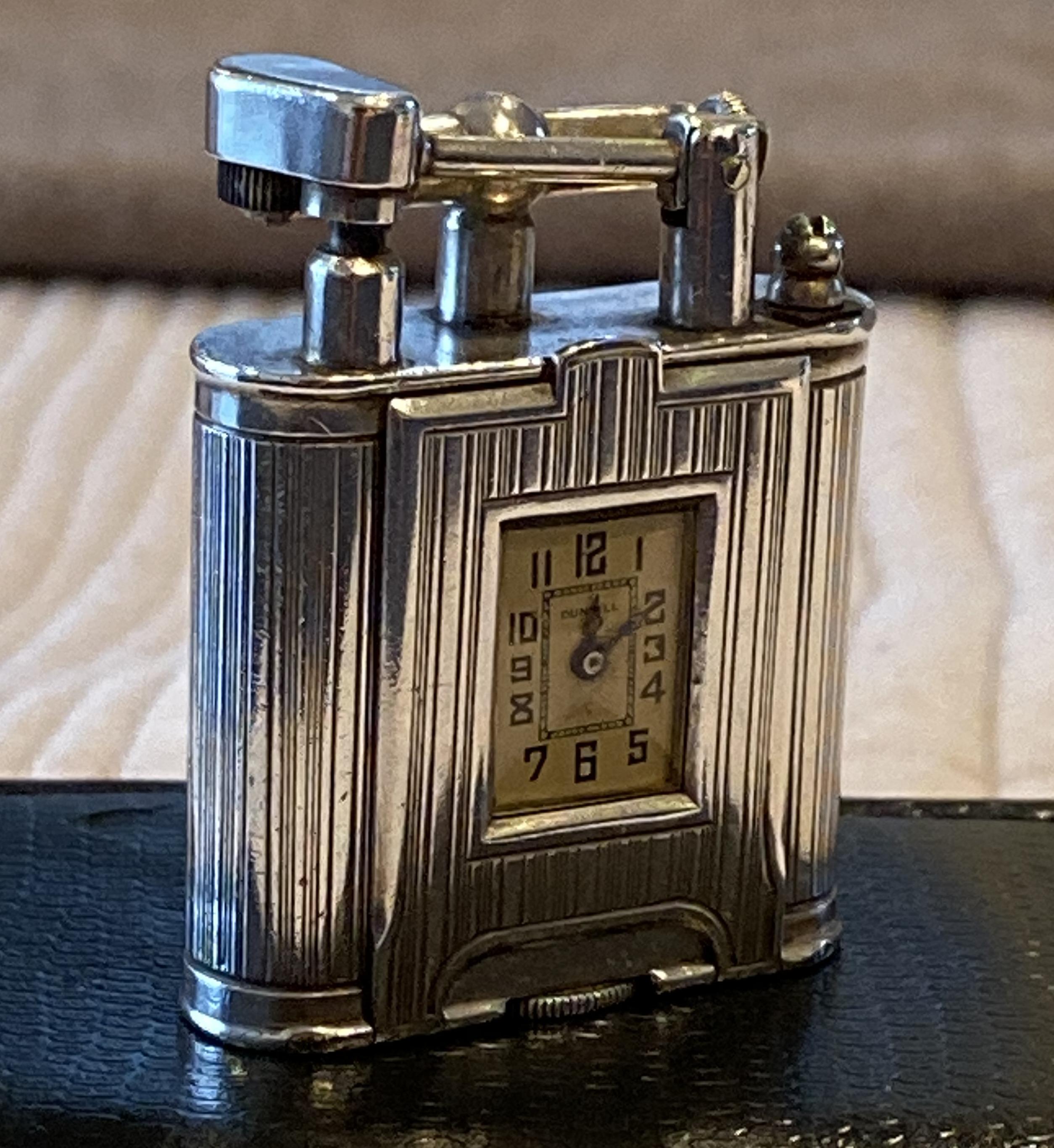 
Wimbledon-Furniture are delighted to offer for sale this stunning hand made in Switzerland sterling silver Alfred Dunhill lighter with built in pocket wrist watch movement

The piece is top to bottom sterling silver and has matching serial numbers