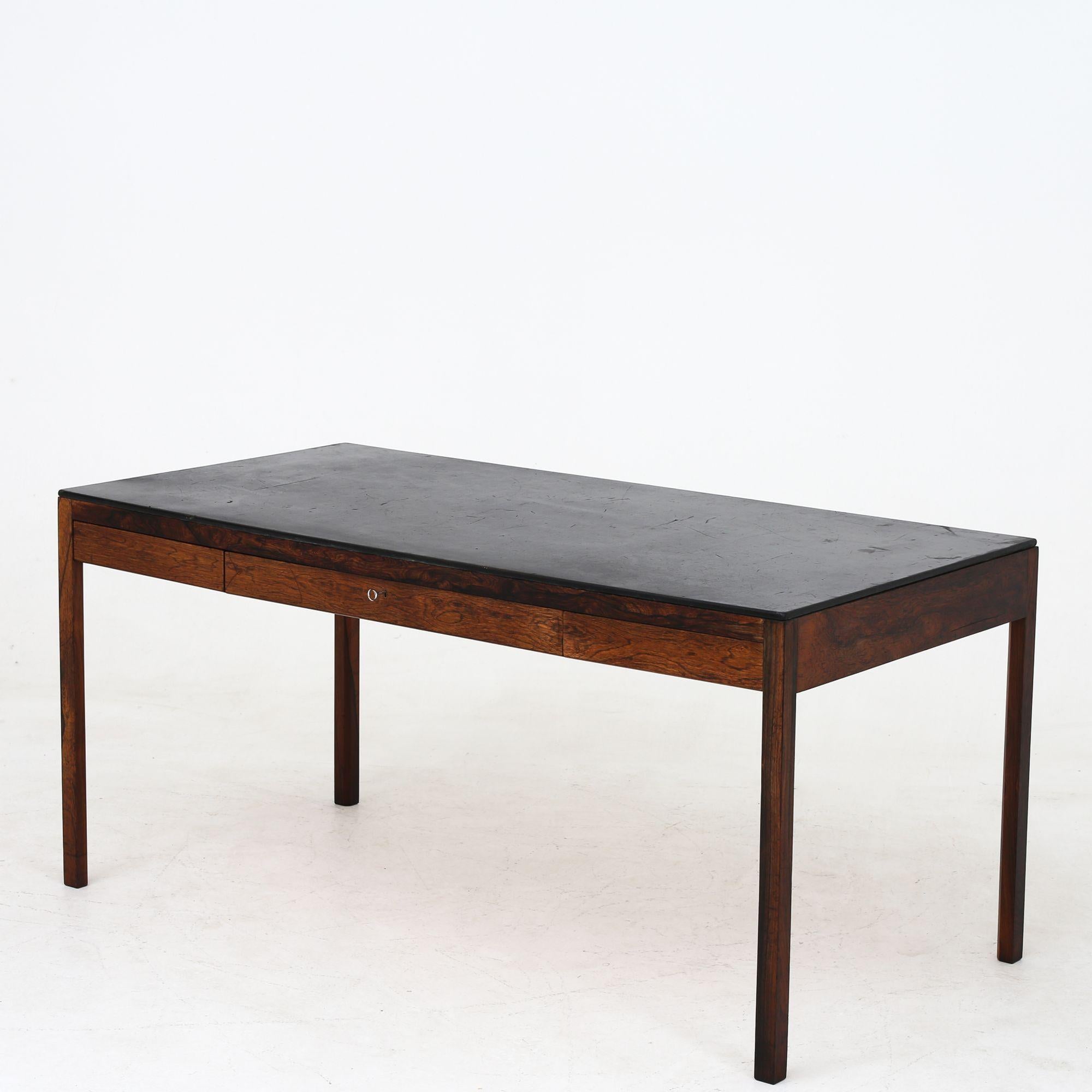 Rare desk in Brazilian rosewood with original leather top of black leather. This specific desk is from the home of Willy Beck. Architects Ejnar Larsen & Aksel Bender Madsen / maker Willy Beck.