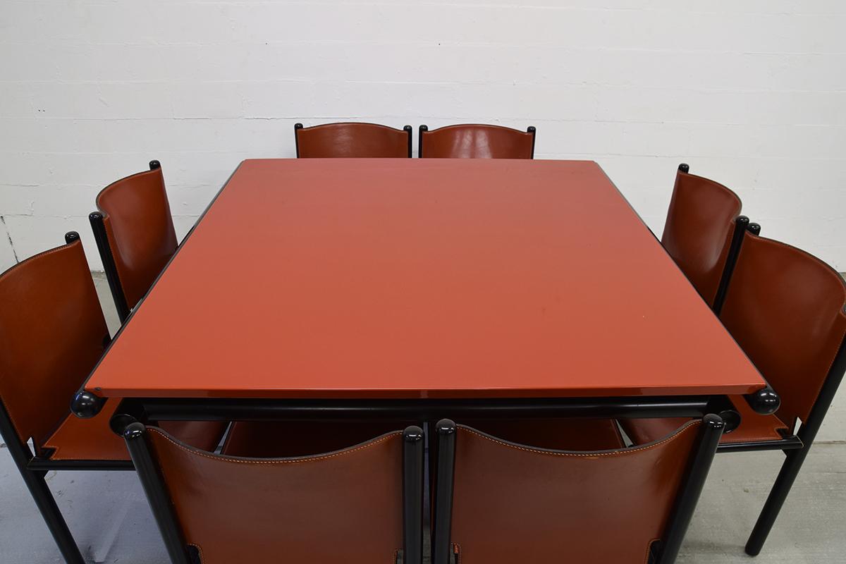 Very rare Modernist dining set consisting of a metal lacquered top 'Capri' table and 8-leather and lacquered wood 'Caprile' chairs. Designed by the famous Italian Modernist Gianfranco Frattini for Cassina in 1985. Inspired this design by his work in
