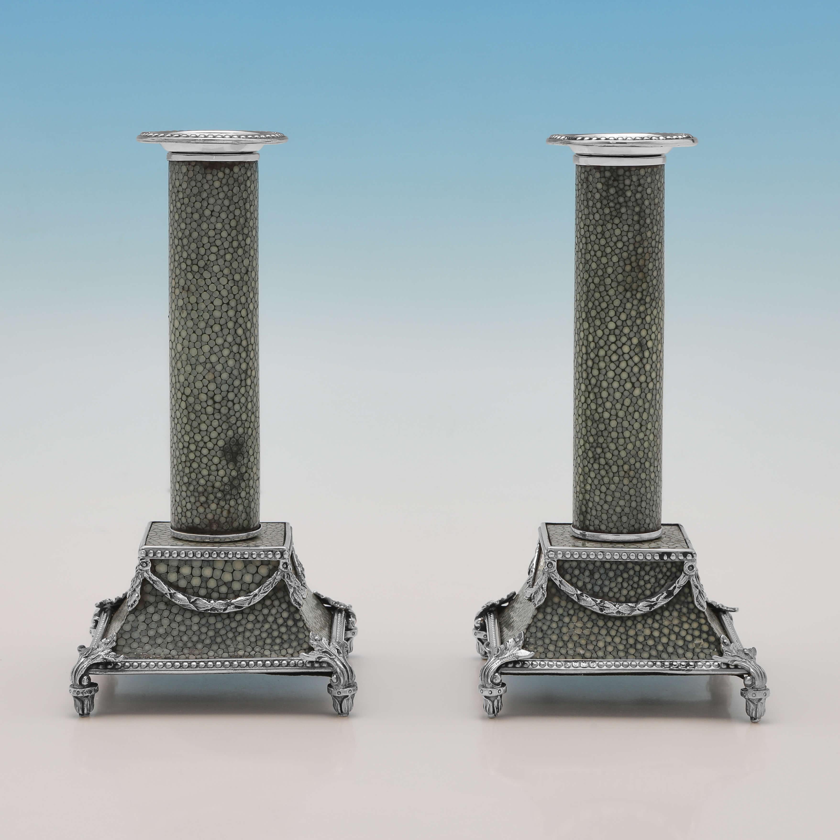 Hallmarked in London in 1910 by Samuel Jacob, this incredible antique sterling silver & Shagreen desk set, comprises a pair of candlesticks, an ink stand and a pen tray, all featuring neoclassical revival silver decoration. 

Each candlestick