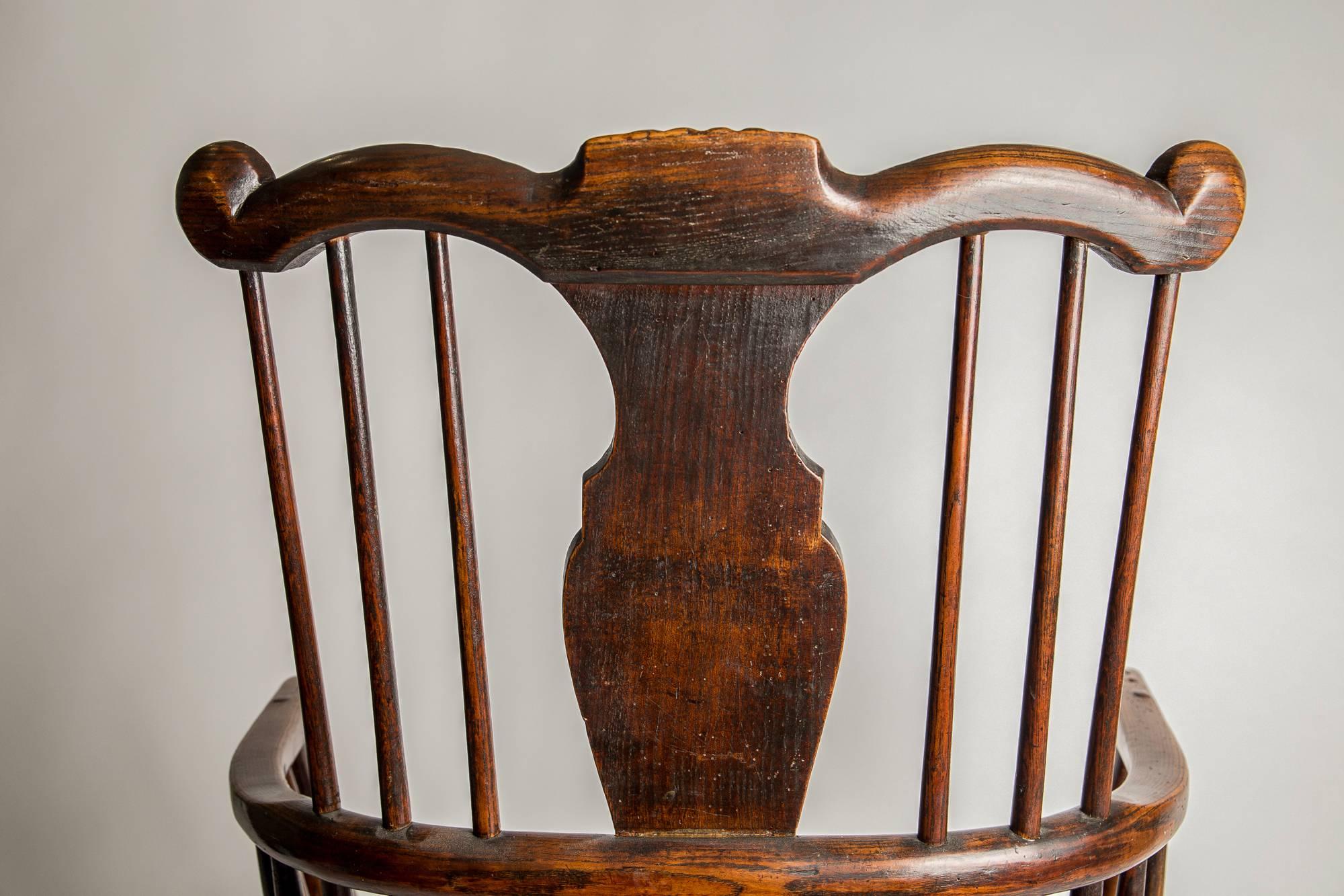 A definitive collectors primitive chair - and certainly an exemplar and rare chair of it's type and age. Of generous and satisfying proportions, the shaped top rail with highly unusual carved shell, terminating in scrolls, with vase-shaped splat and