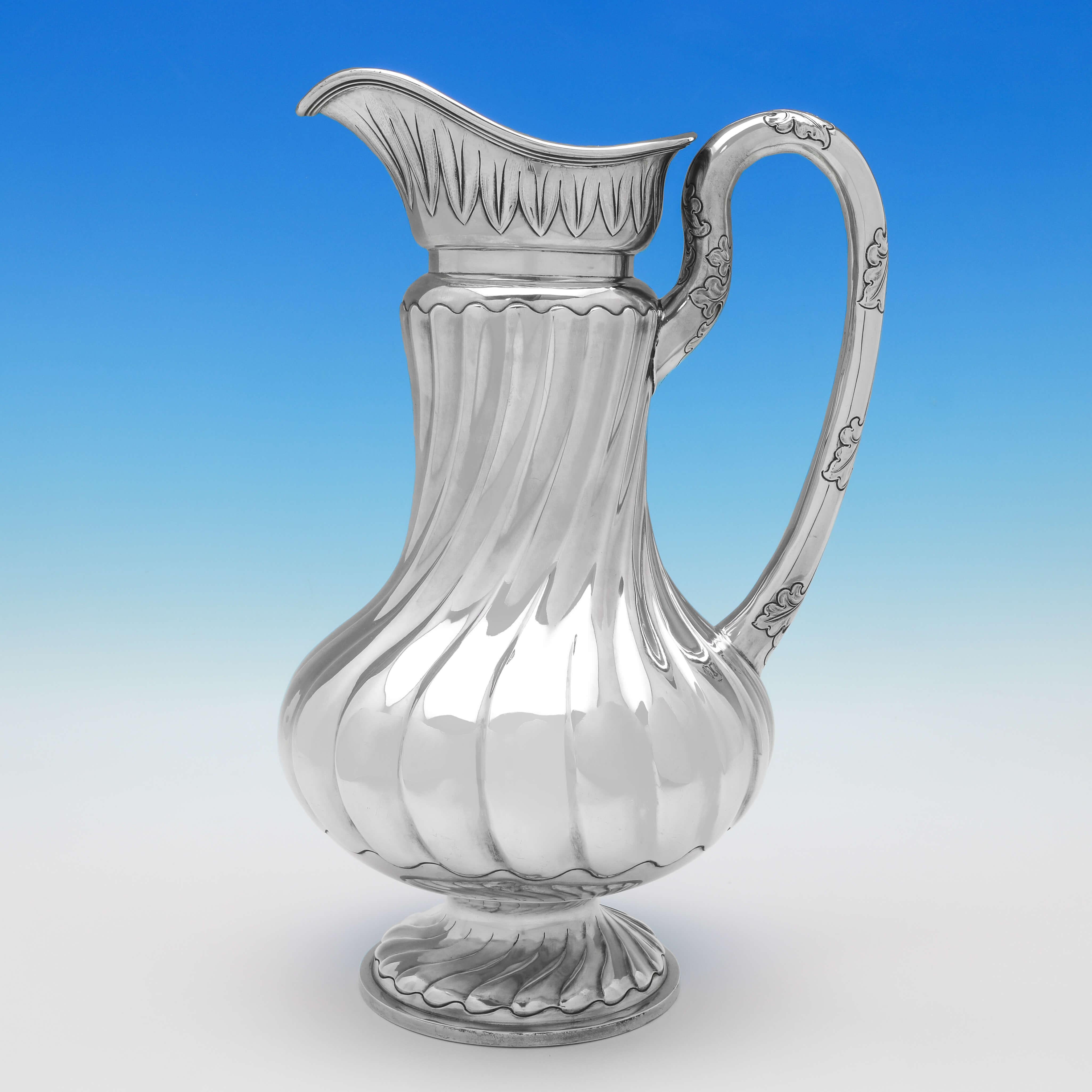 Hallmarked in London in 1891 by Joseph & Horace Savory (trading as the Goldsmiths Alliance) this rare, English, Antique Sterling Silver Ewer & Basin, features sunken and swirled fluting, and acanthus detailing to both pieces. 

The ewer measures