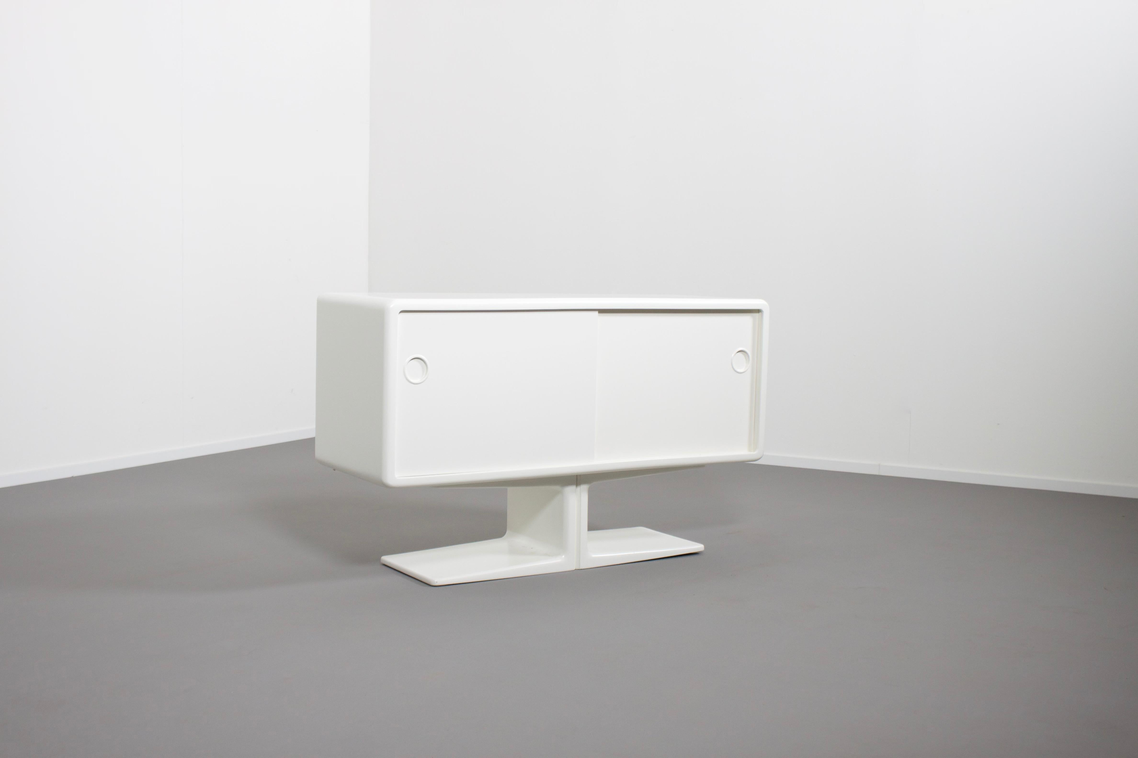Beautiful Space Age cabinet by Ernest Igl for Wilhelm Werndl Completely restored, in very good condition.

Body made of molded fiberglass, lacquered white sliding doors made wood.

All sides of the cabinet are finished so it can be used as a room