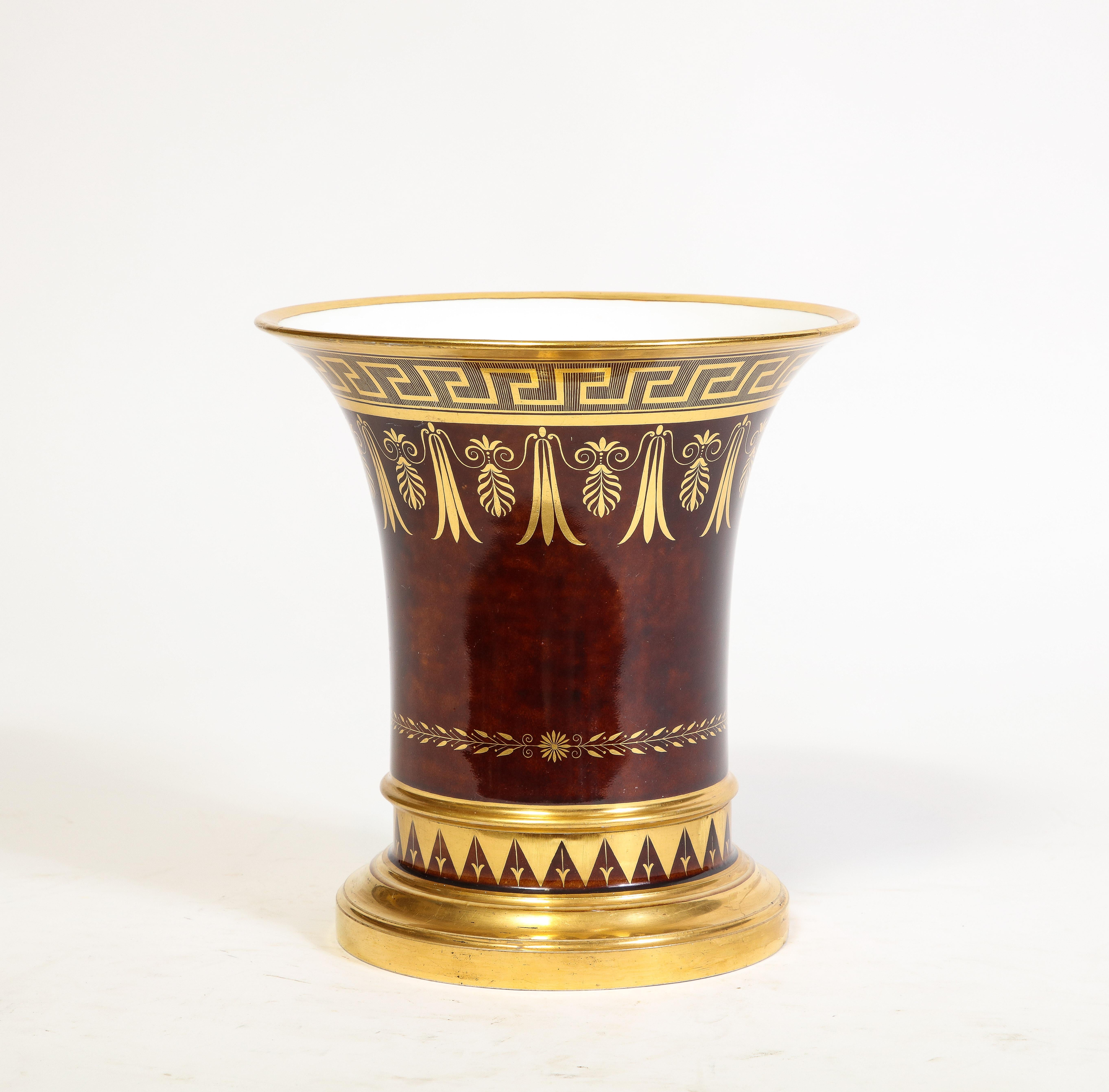 An Exceedingly Rare 19th Century French Sevres Faux Bois Flower-Pot and Underplate, Signed with Sevres Marks.  This stunning piece features a beautiful rounded rich handcrafted faux wood body, adorned with a gilt Greek Key-Scroll framed band