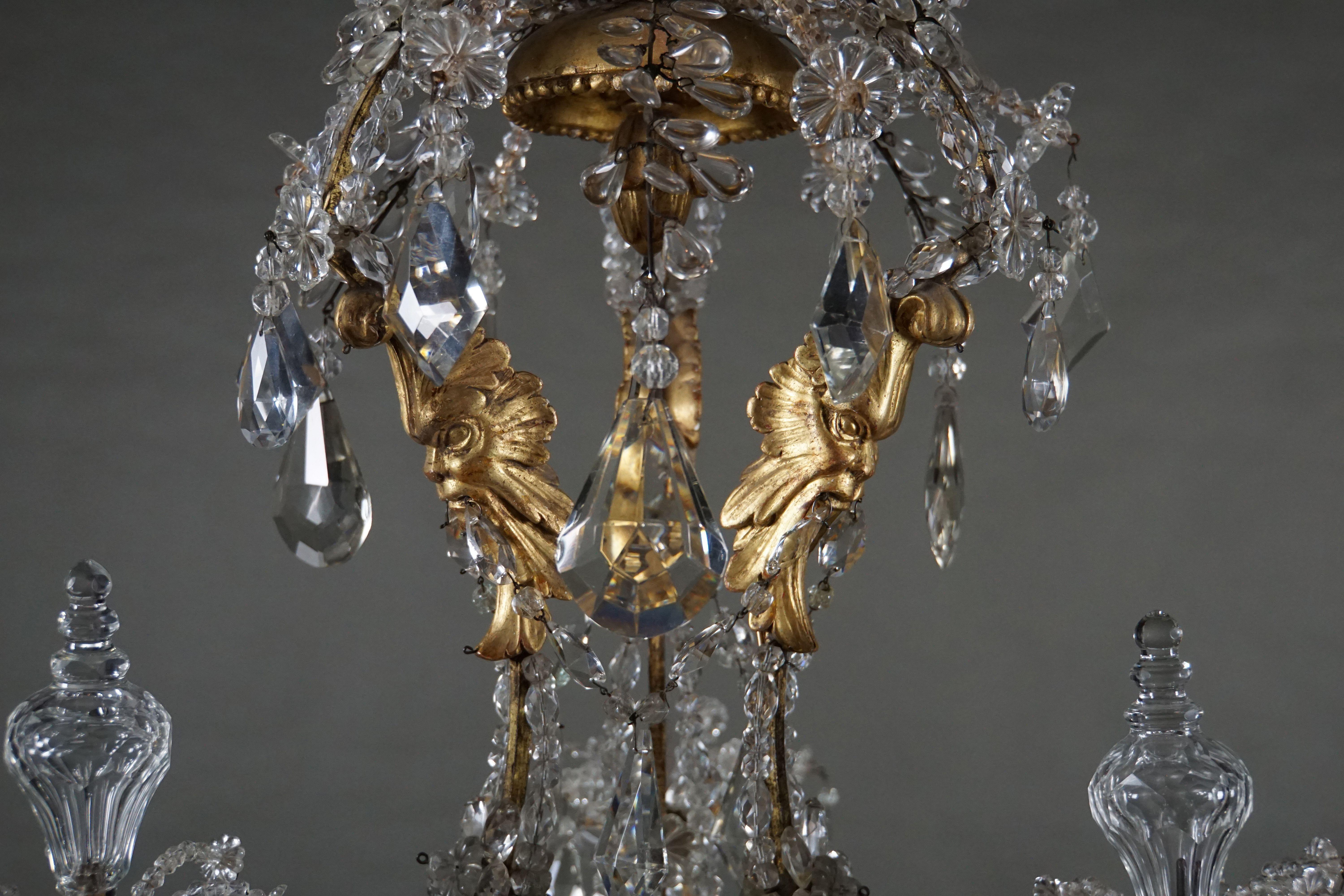 Important and very rare Genuese carved and gilded chandelier with grotesque masks and fine crystal decoration. Italy. Genoa, circa 1770.