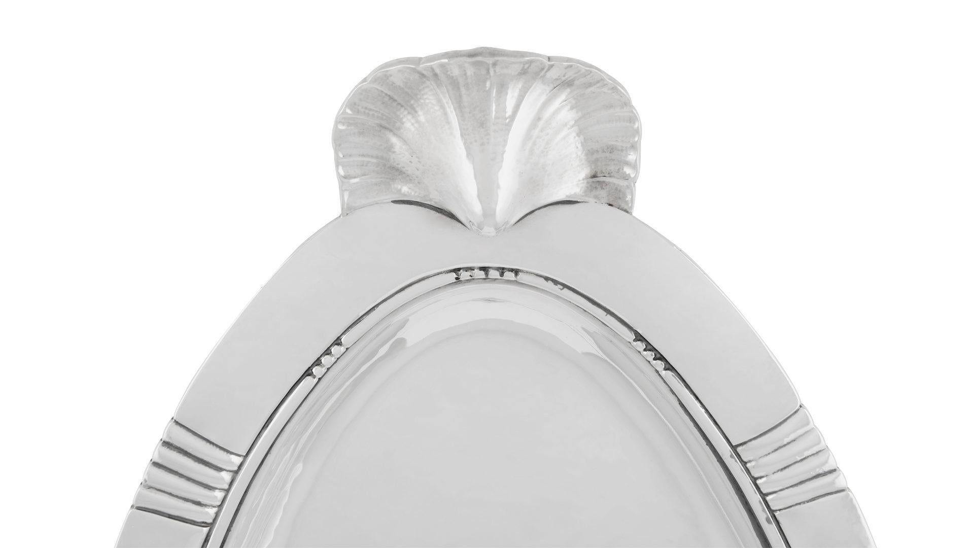 This is a very rarely seen sterling silver Georg Jensen oval fish platter with shell-shaped handles, design #335B by Johan Rohde from circa 1919.

Very long at 29½” x 11 5/8? (74.5cm x 29.5cm). Weighs 67.35oz (1.91kg).

Vintage Georg Jensen