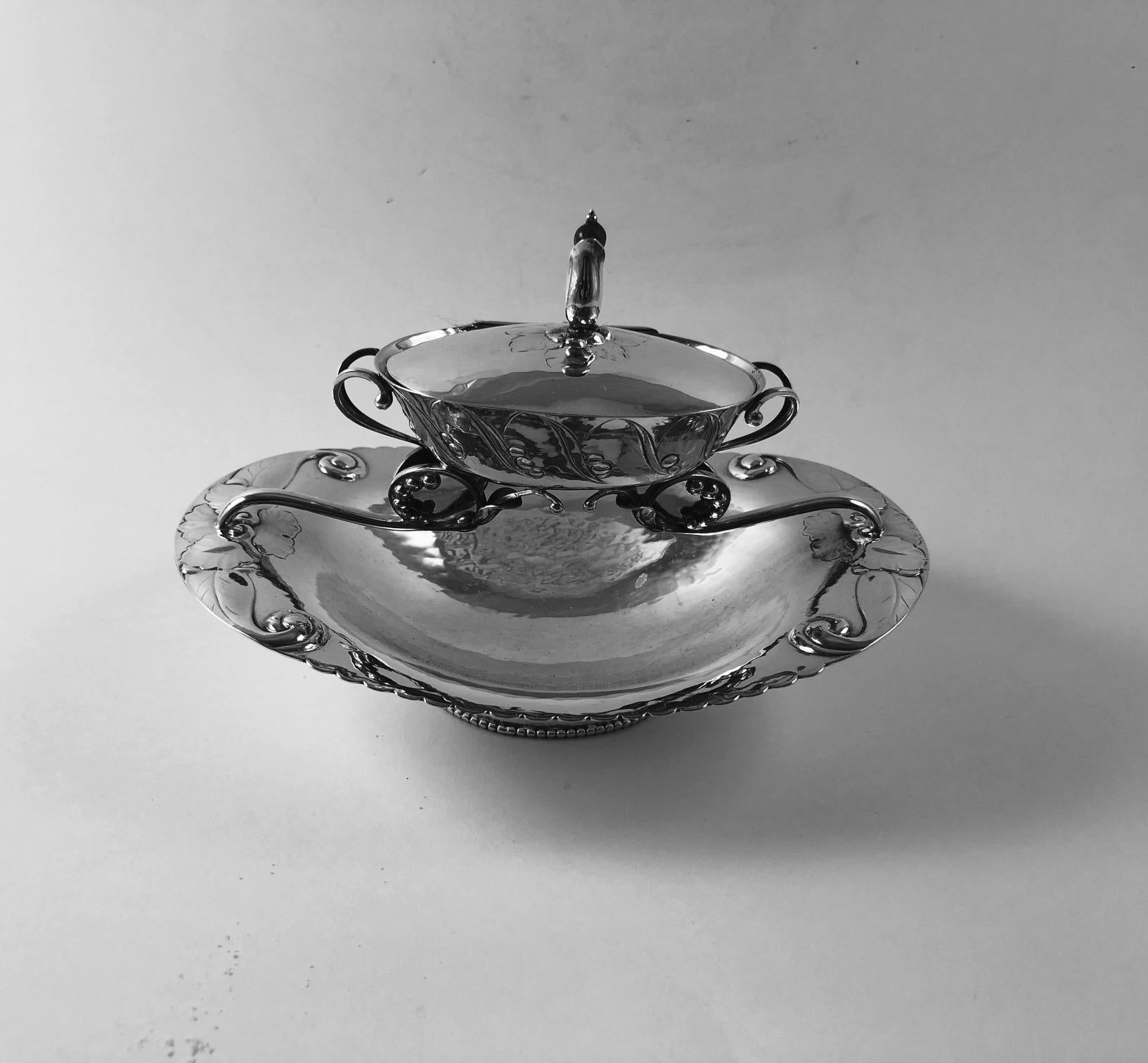 Georg Jensen early two-tiered oval handcrafted 830 silver dish with amber finial, design #81 by Georg Jensen. Most likely used as an ashtray and the top tier to hold match sticks. This piece is date stamped 1919 Georg Jensen hallmarks and at that