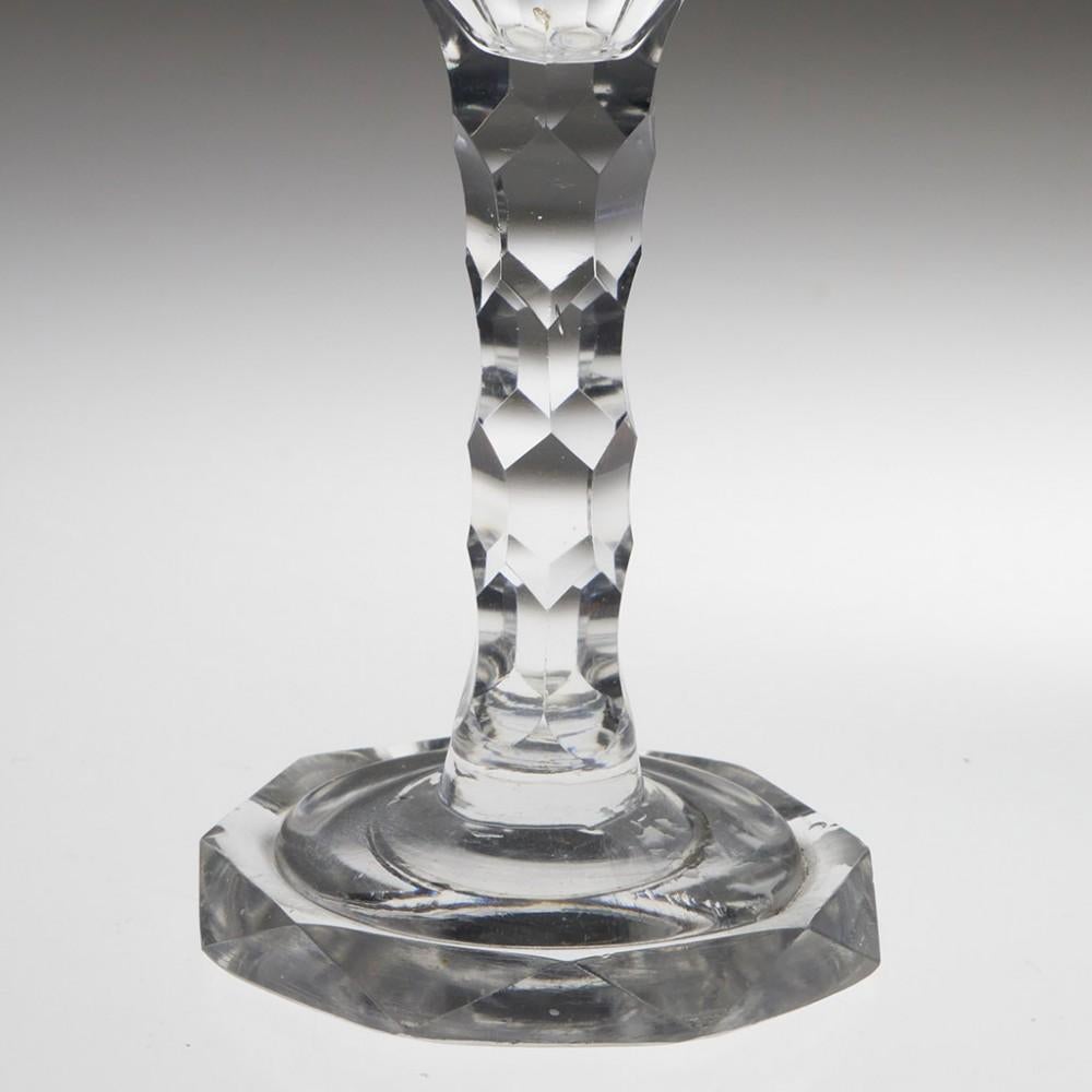 Heading : 18th century facet cut stem wine glass
Period : George III
Date : c1800
Origin : England
Colour : Clear
Bowl : An ogee bowl engraved with OXO swags. Further facet cuts to the base of the bowl
Stem : Hexagonal facet cuts
Foot : Octagonal,