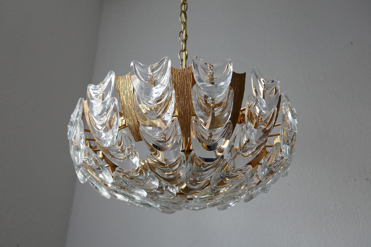 Beautiful gold-plated brass and geometric crystal glass chandelier.
Germany, 1960s.
Height (Body): 10.5 in
Lamp sockets: 6
      

 