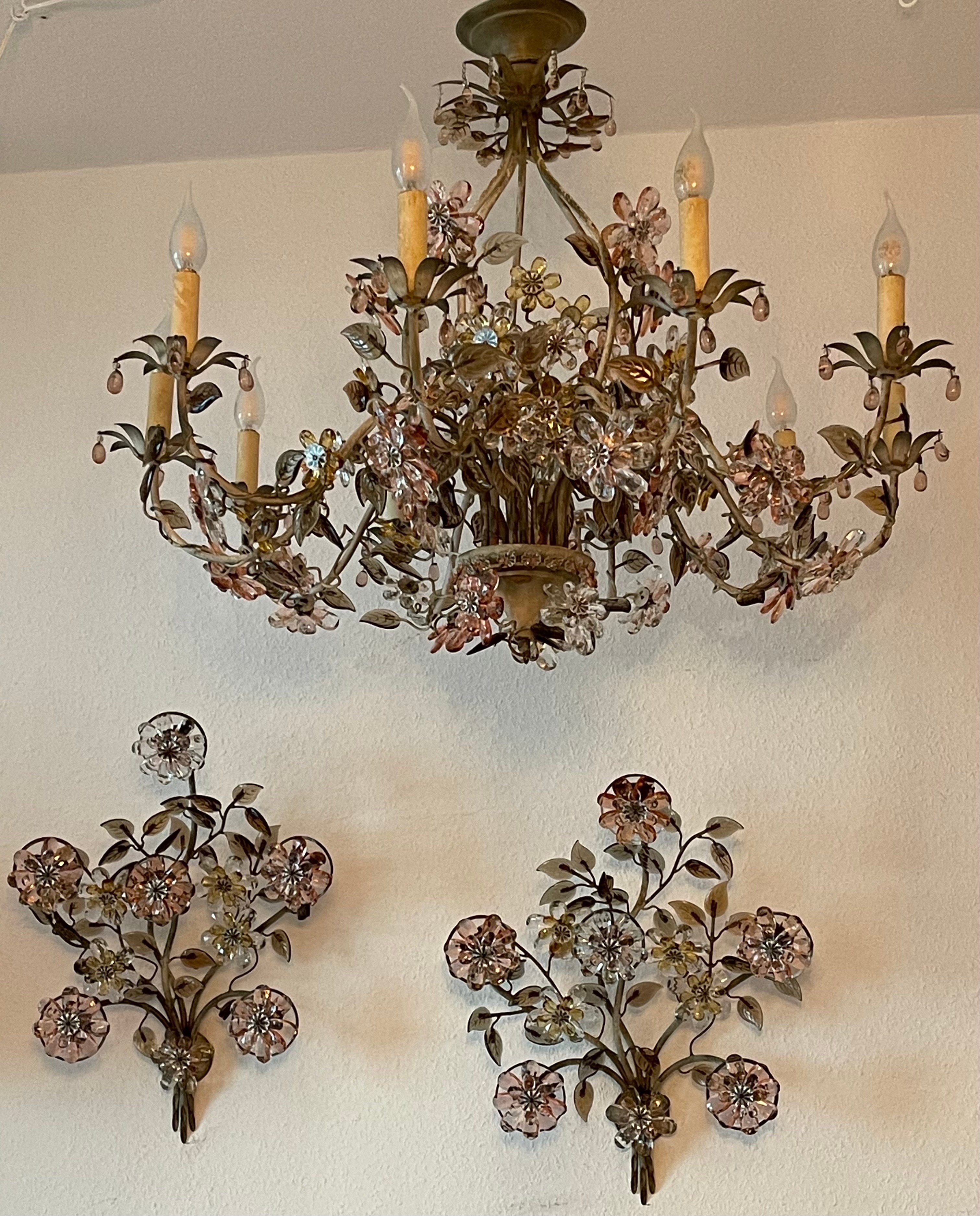 A rare set of three light fixtures designed by Oswaldt Haerdtl for Lobmeyr, circa 1950s, Vienna, Austria. 
This large chandelier and a pair of sconces are made of white/gray painted brass decorated with numerous pink, yellow, white glass flowers and