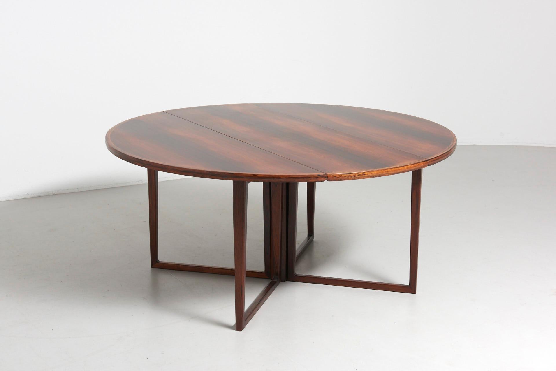 A very rare dining table, designed by Helge Sibast and produced by Sibast Møbler in Denmark in the 1960s. The foldable tabletop and sliding legs are all in solid Brazilian rosewood. The table is in very good condition.