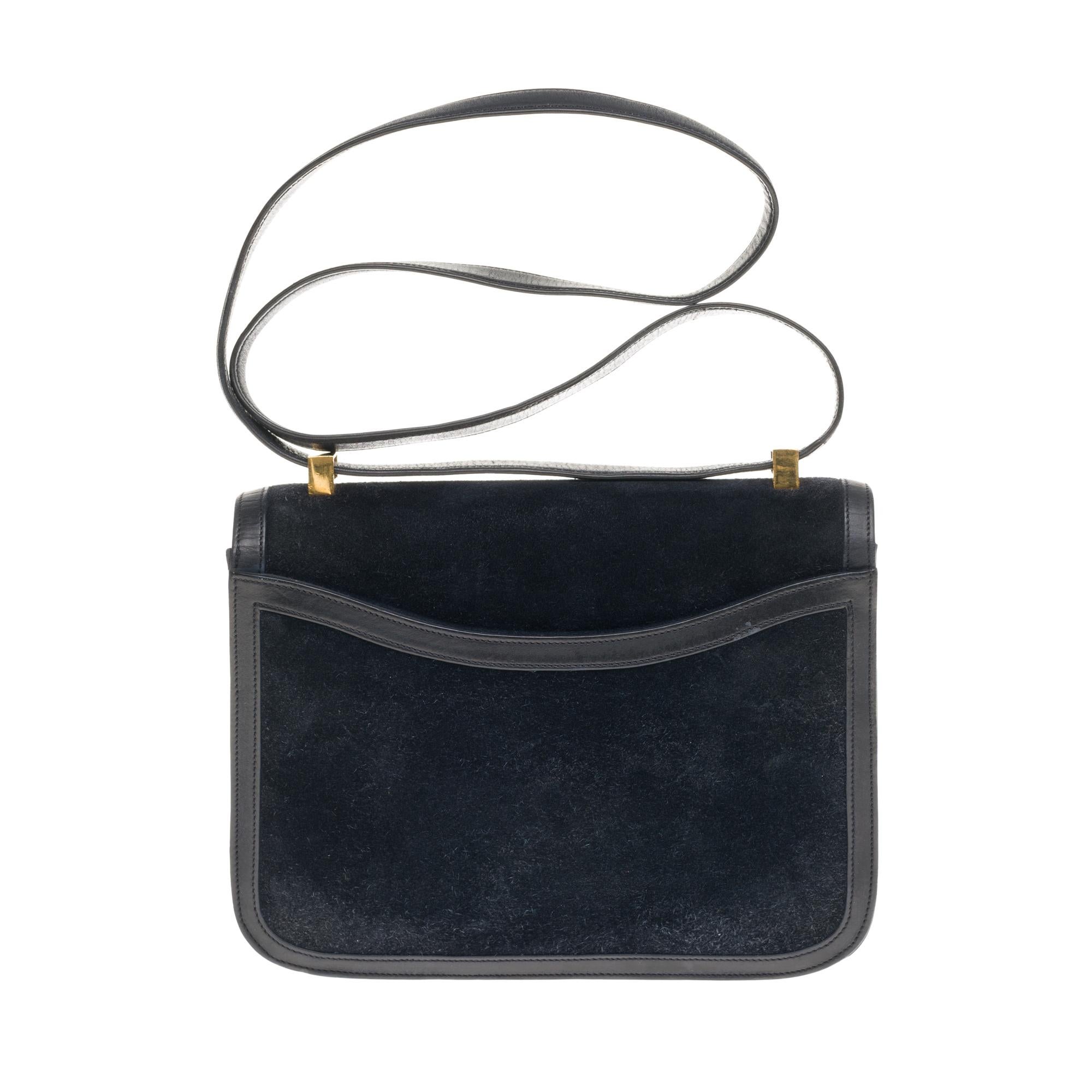 
Rare & Splendid Hermes Constance Handbag 23 cm Doblis Leather Box and Navy Blue suede, Gilded Metal Trim, Convertible Handle to Navy Leather Box For Carrying Hand or Shoulder.

Closure marked H on flap.
A patch pocket on the back of the bag.
Navy