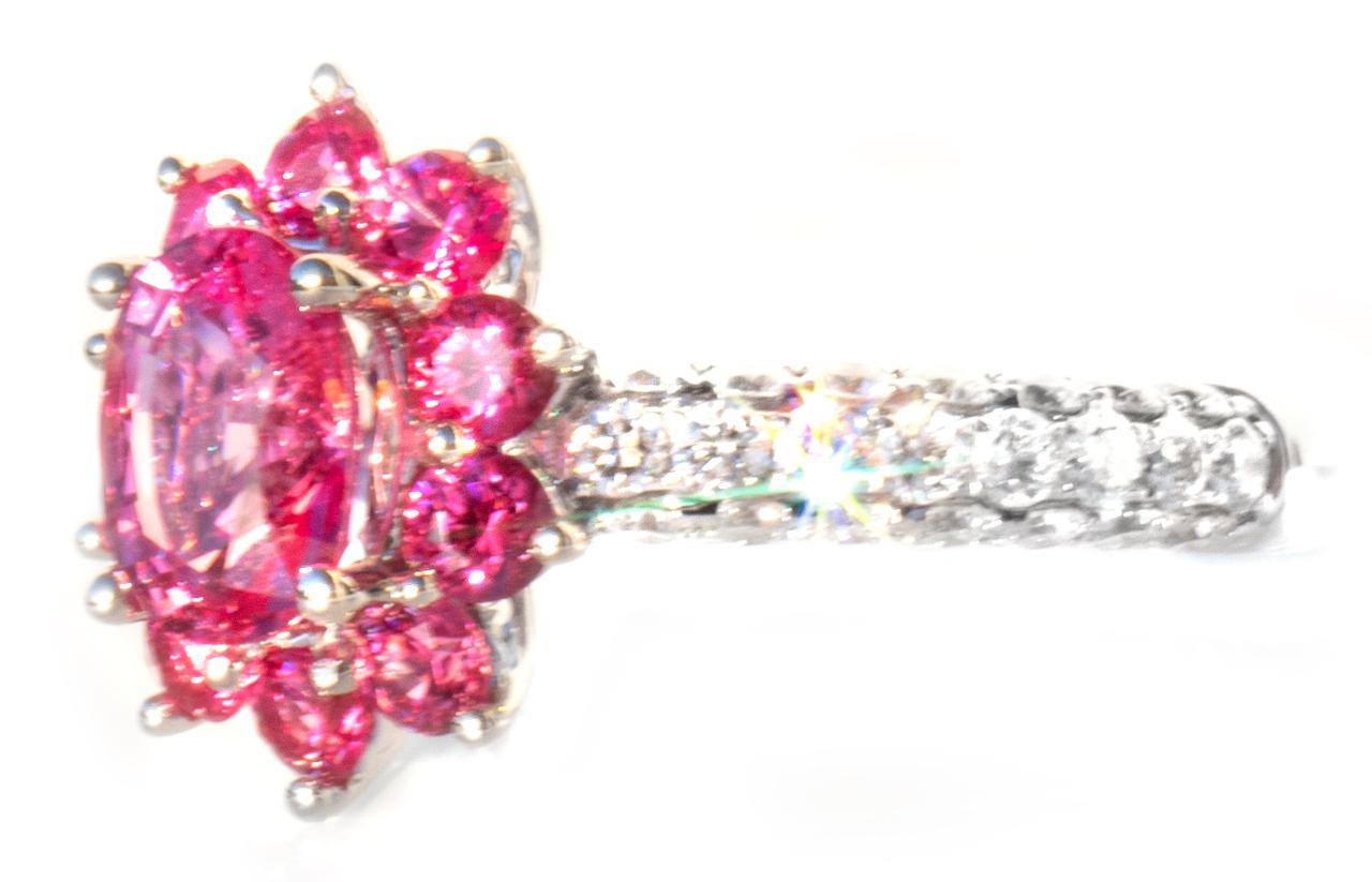 As a gemologist, I see beautiful gemstones a lot. I think these hot pink spinels are of the finest we've seen. We designed and manufactured this ring for total joy. The band has 3 sides of VVS colorless diamonds, with larger diamonds in the center