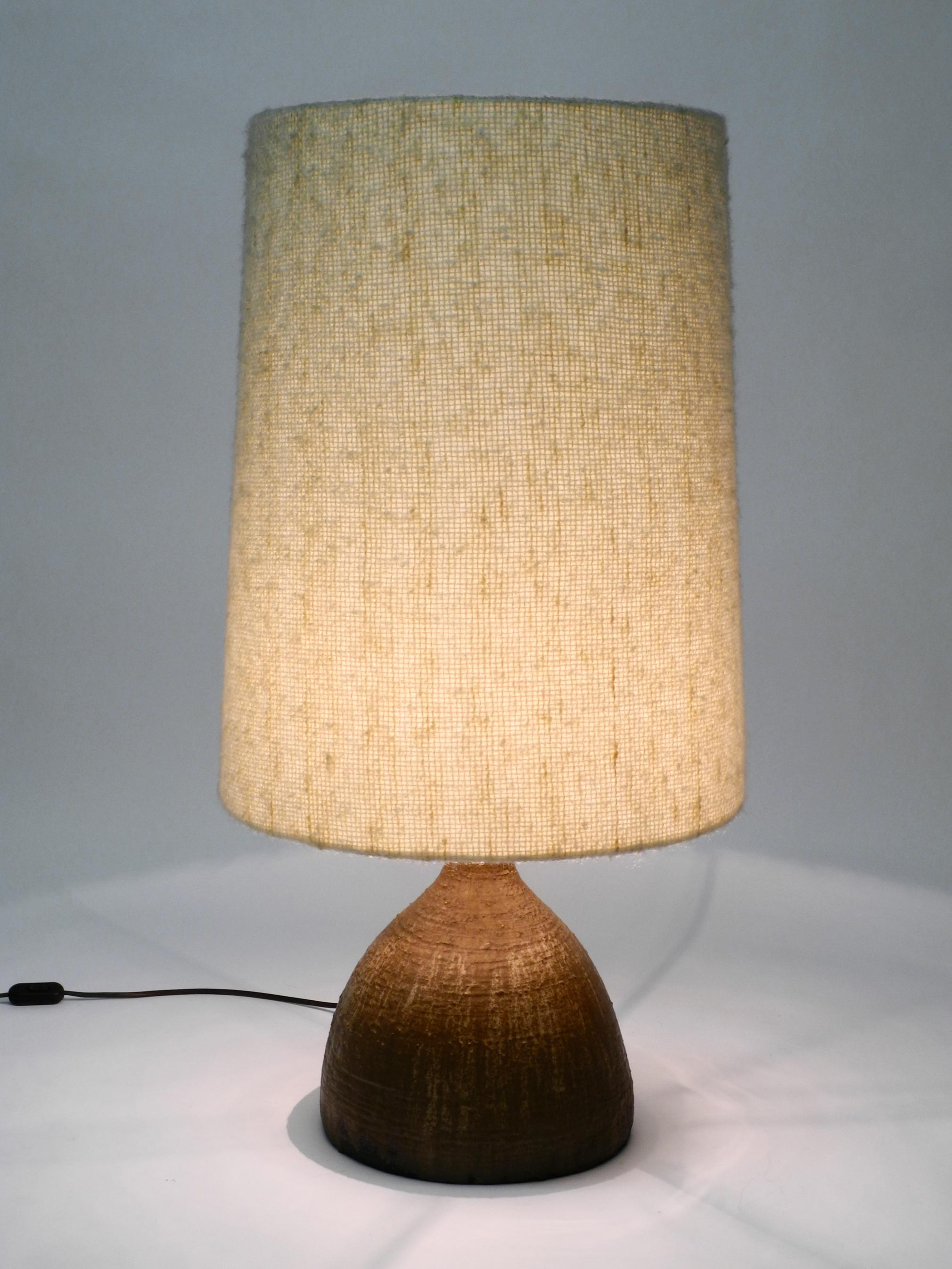 Very rare, huge 1960s German ceramic table or floor lamp with a large fabric shade.
Heavy, large artful ceramic foot in mocha brown.
The original shade is made of a beige fabric shade that has the feel of wool.
Very high quality workmanship.
No