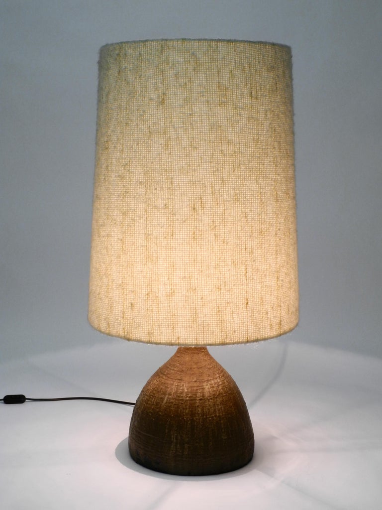 Very rare, huge 1960s German ceramic table or floor lamp with a large fabric shade.
Heavy, large artful ceramic foot in mocha brown.
The original shade is made of a beige fabric shade that has the feel of wool.
Very high quality workmanship.
No