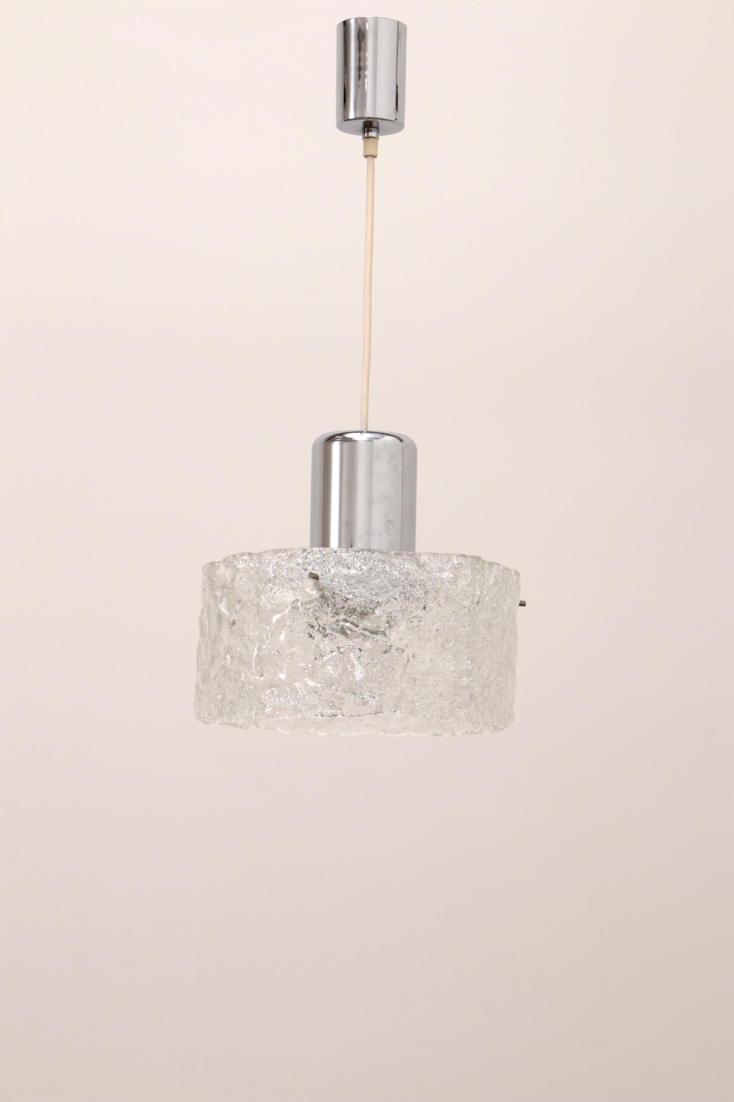 
Very rare ice glass lamp produced by Egon Hillebrand in Germany in the late 1960s. The pendant lamp consists of a large ring of ice glass, which is held by an elaborate chrome-plated suspension. The glass shade is attached to the suspension with
