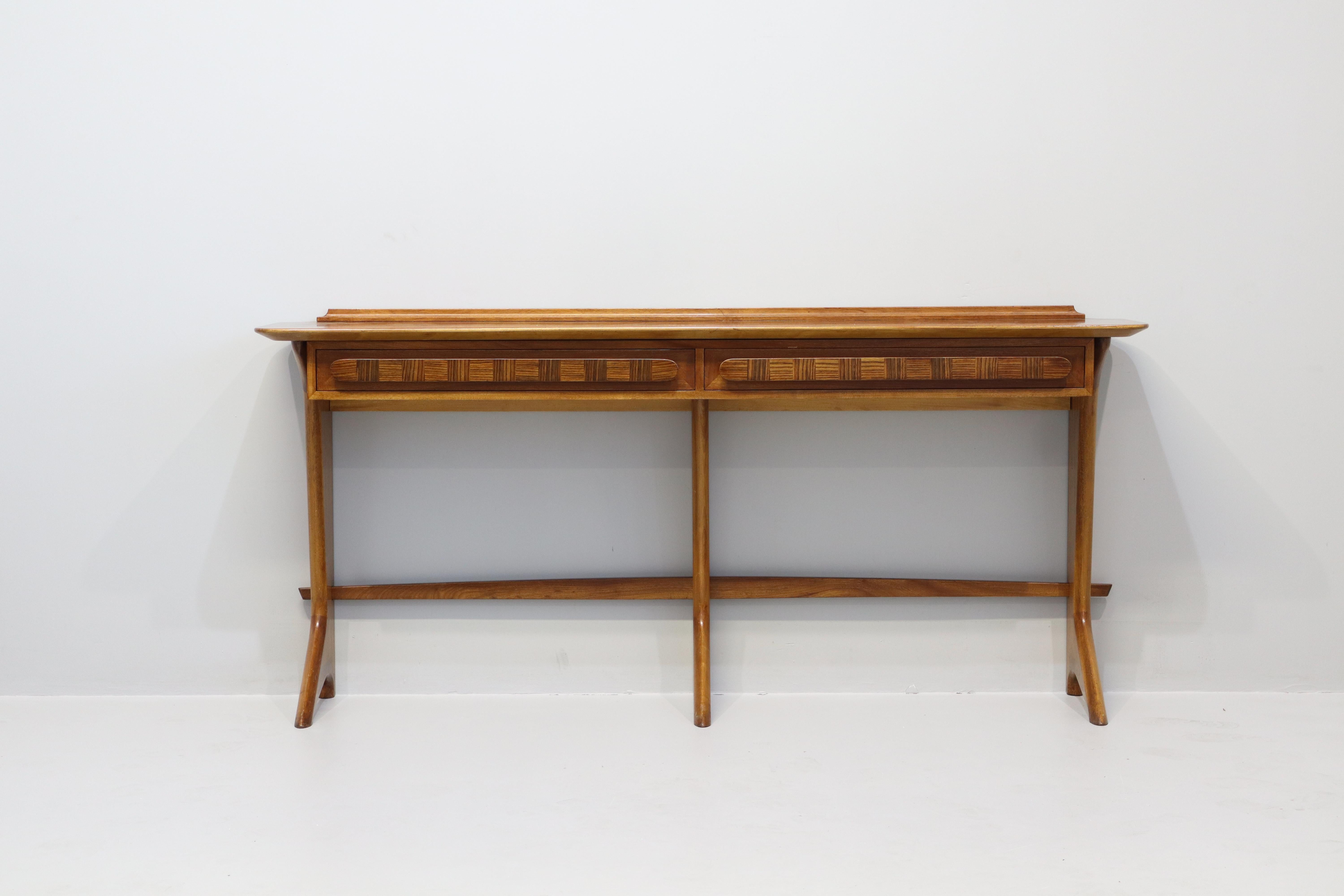 Rare and important Italian Mid-Century Modern console in Italian momahogany by Ico Parisi. Sculptural form with 2 drawers and herringbone inlay to top and throughout. 2 pieces are known to have been made. A daring piece of architecture and design
