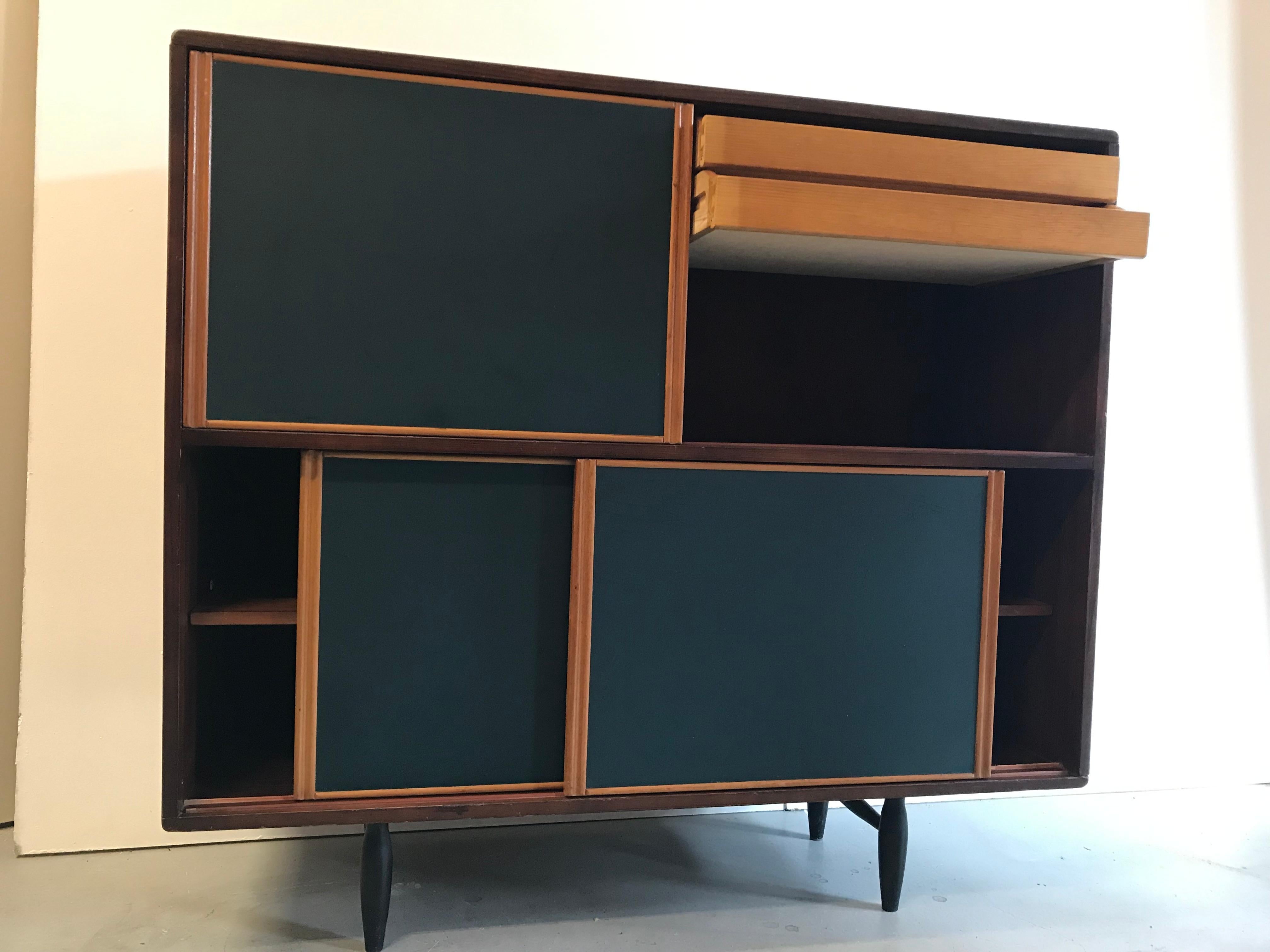 Sideboard from designer Ilmari Tapiovaara for Laukaan Puu. Finland 1950s.
Sideboard ‘Pirkka’ is a handsome sized cabinet with four doors and inside shelves.
Stands on four solid feet. Pine edition with pretty blue colored, original, doors.