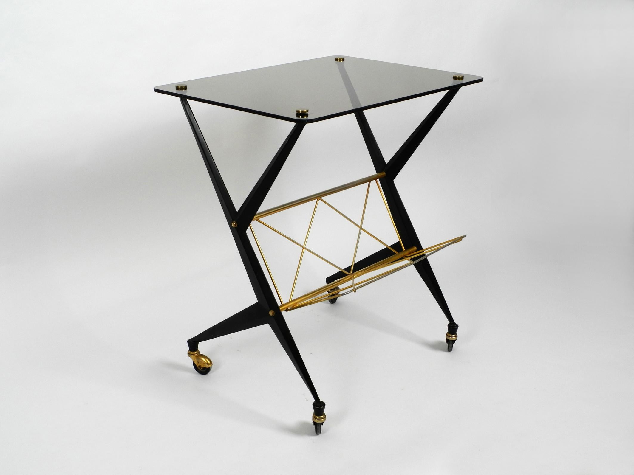 Very rare Italian midcentury side table with a newspaper shelf.
Designed by Angelo Ostuni for Frangi Milano. Made in Italy.
Great uncommon 1950s Italian design.
Because of the height, it can also be used as a console table or bar trolley.
Black