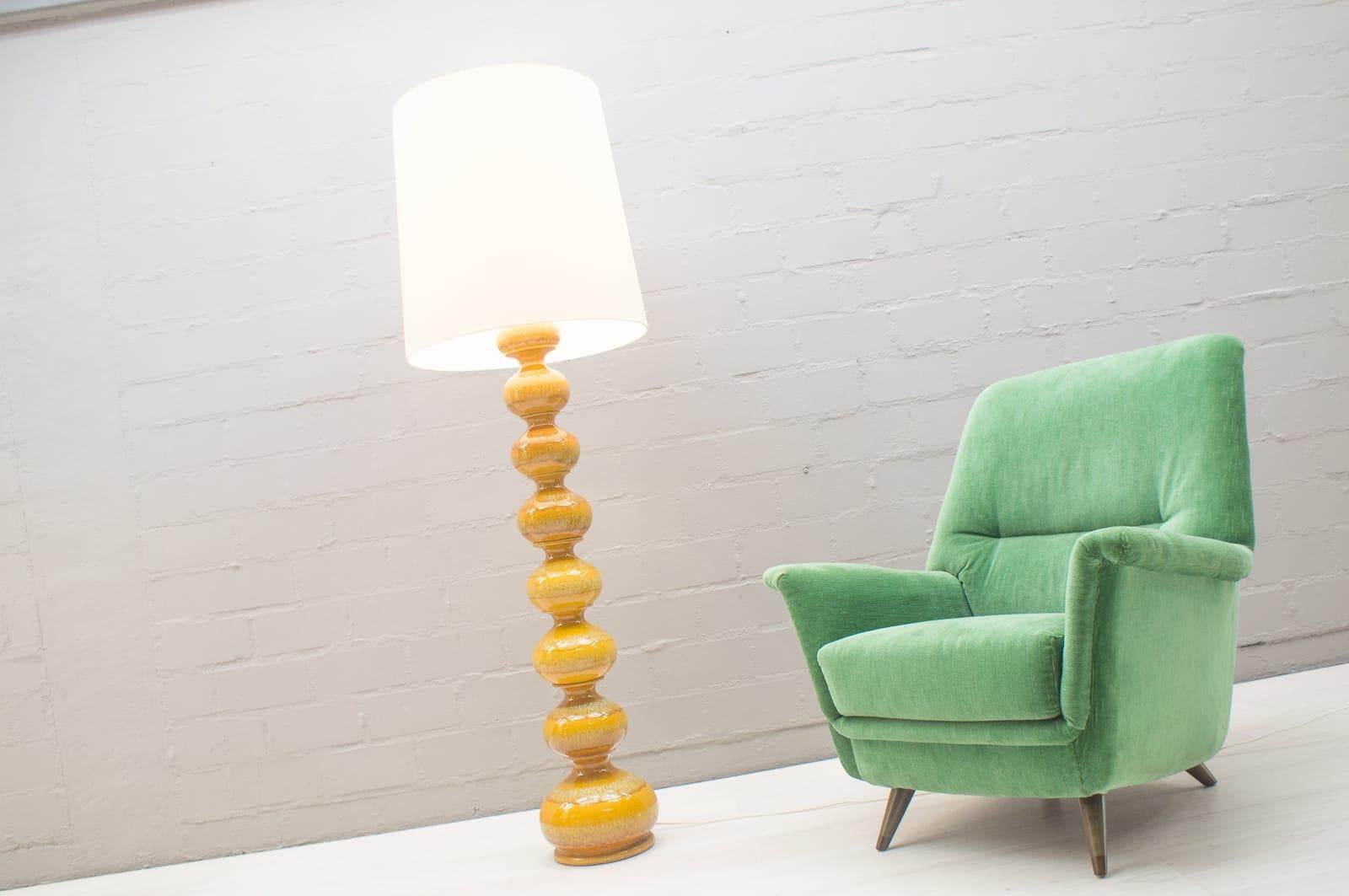 These ceramic floor lamps were designed in the 1960s. 
The skylight and the two inner lights can be turned on separately. 
We have had the lampshades reupholstered.
We have two more same floor lamps and several table lamps.