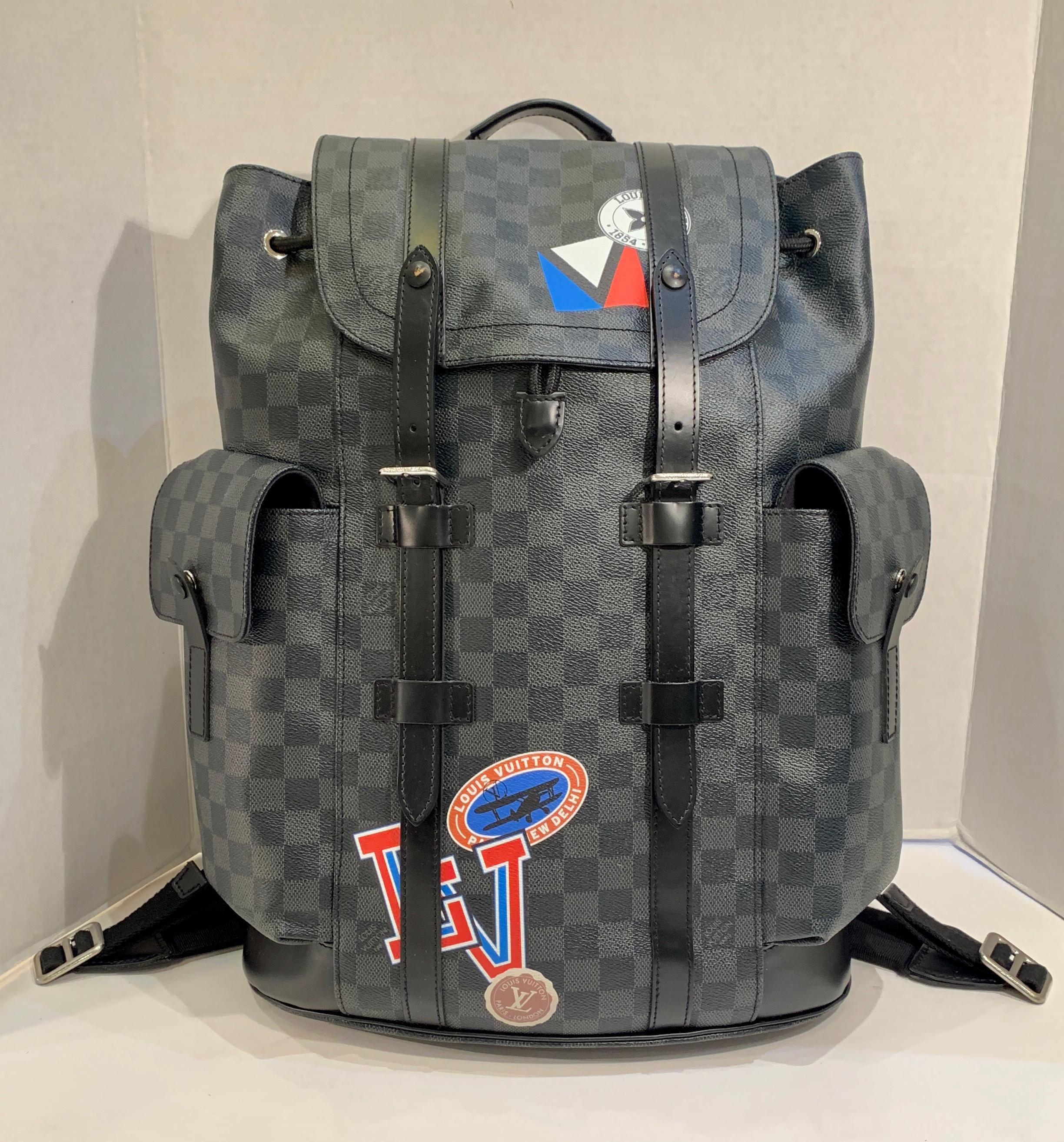 Rare and collectible, special edition, authentic LOUIS VUITTON Damier Graphite Christopher PM Backpack with Louis Vuitton un-customized factory retro style LV travel decals as part of the pattern is crafted of Louis Vuitton signature Damier black