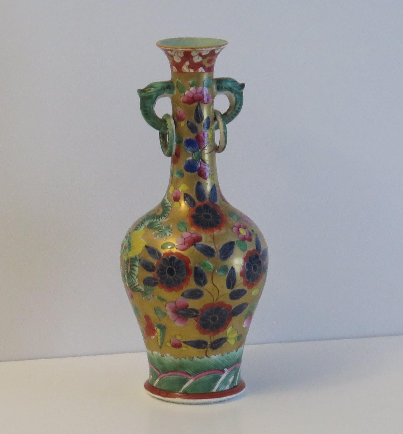 This is a very rare ironstone vase, in the Chinese style, all hand painted in the coloured dragon pattern, made by the Mason's factory in the early 19th century.

Both the vase shape and the pattern are very rare.

The vase has a bottle shape with a