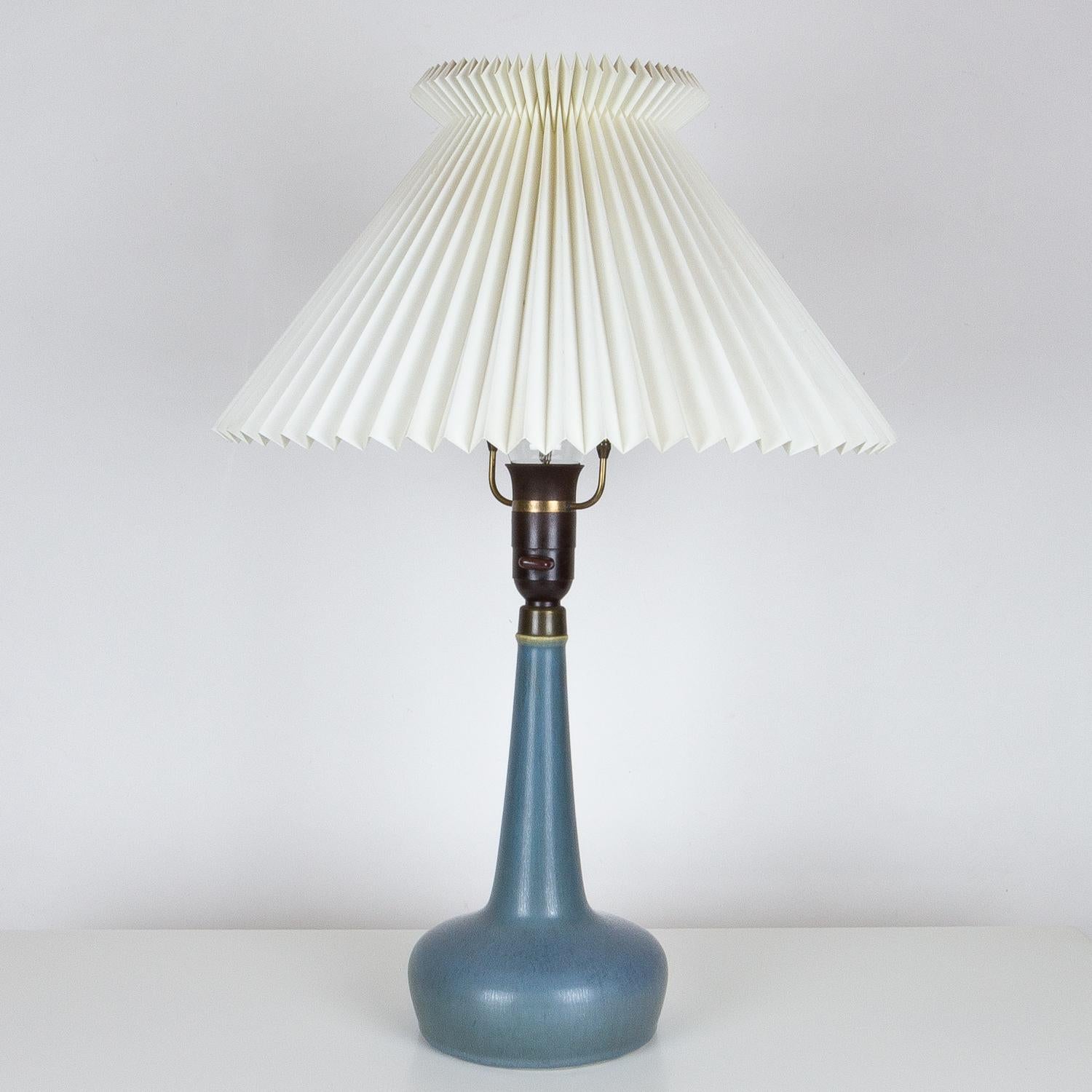 This 311 lamp was designed by Esben Klint in 1949 and produced by Danish ceramic company Palshus for Le Klint. The lamp is ceramic with original brass shade fittings and Le Klint shade. The Danish pottery Palshus was run by Annelise and Per