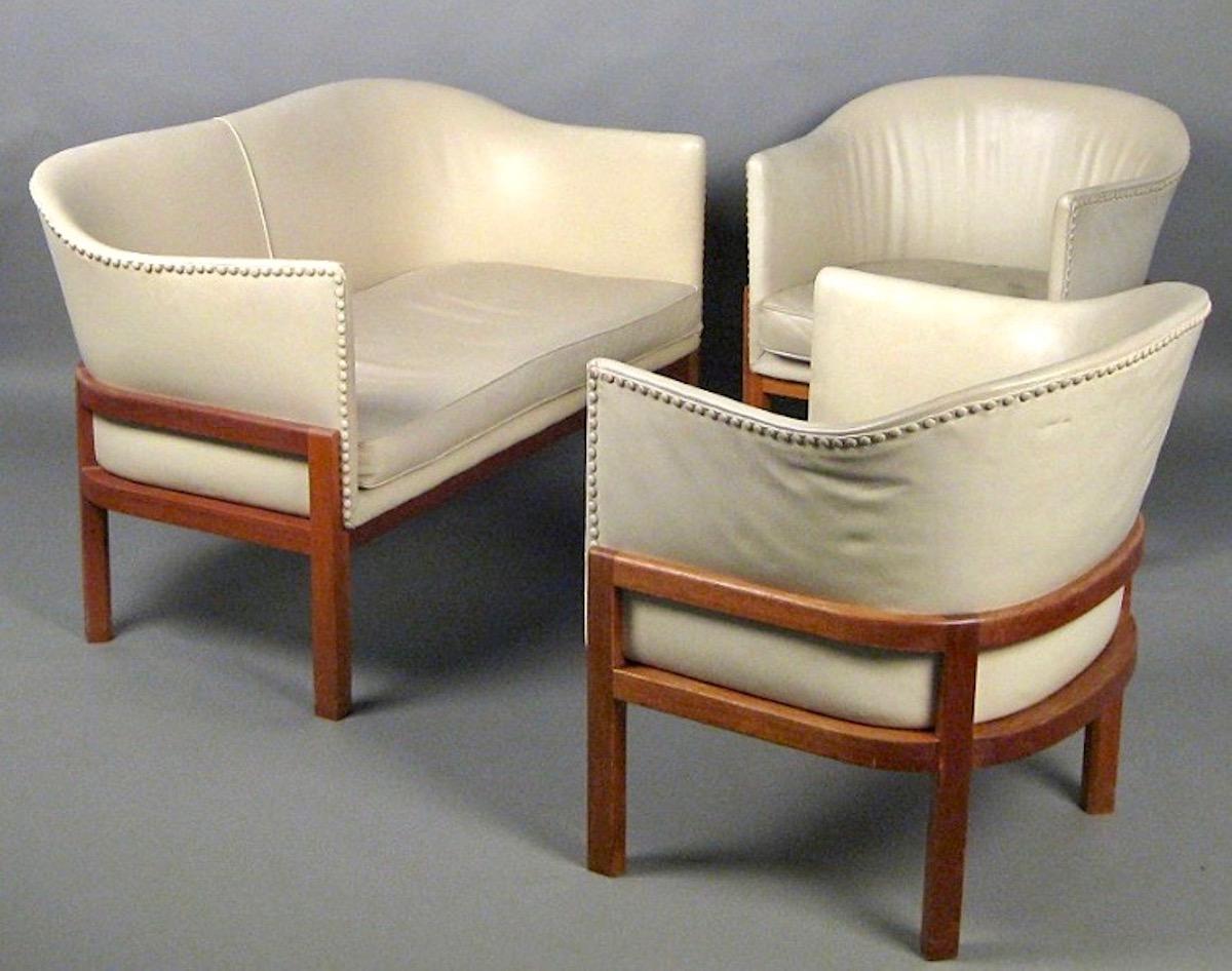 All original with ivory colored leather and mahogany base. Made around 1970 by Ivan Schlechter. Designed 1940.