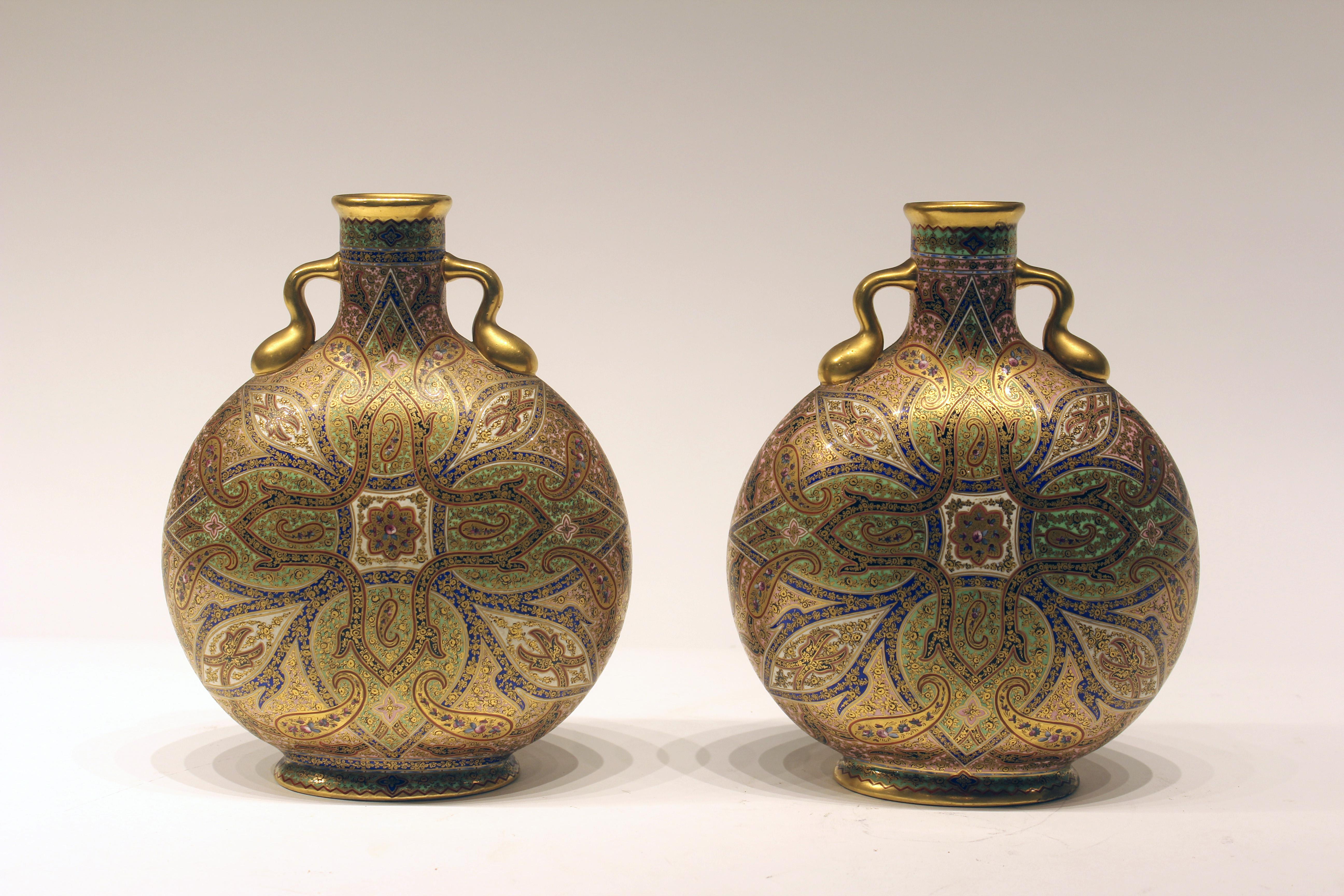 Pair of very rare early 19th century Coalport Moon vases. Enameled and hand painted with original mercury gold. Additional set of 11 service plates are available upon request.
