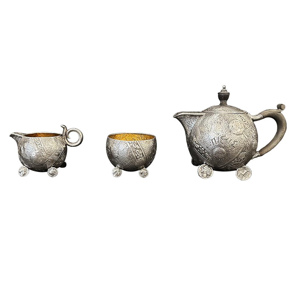 Exquisite sterling silver tea set crafted by the renowned Elkington & Co in collaboration with the esteemed American designer George Shieber. This exceptional tea set is a true masterpiece of craftsmanship and design. Comprising three exquisite