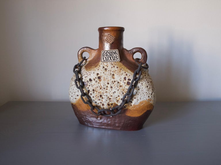Stunning very rare Mid-Century Modern Fat lava ceramic vase.
Very unique vase with an iron chain. The chain would allow you to hang it on a wall.
Collectors piece with original label.

This vase from the famous Tönnieshof Luxus Series.

Form