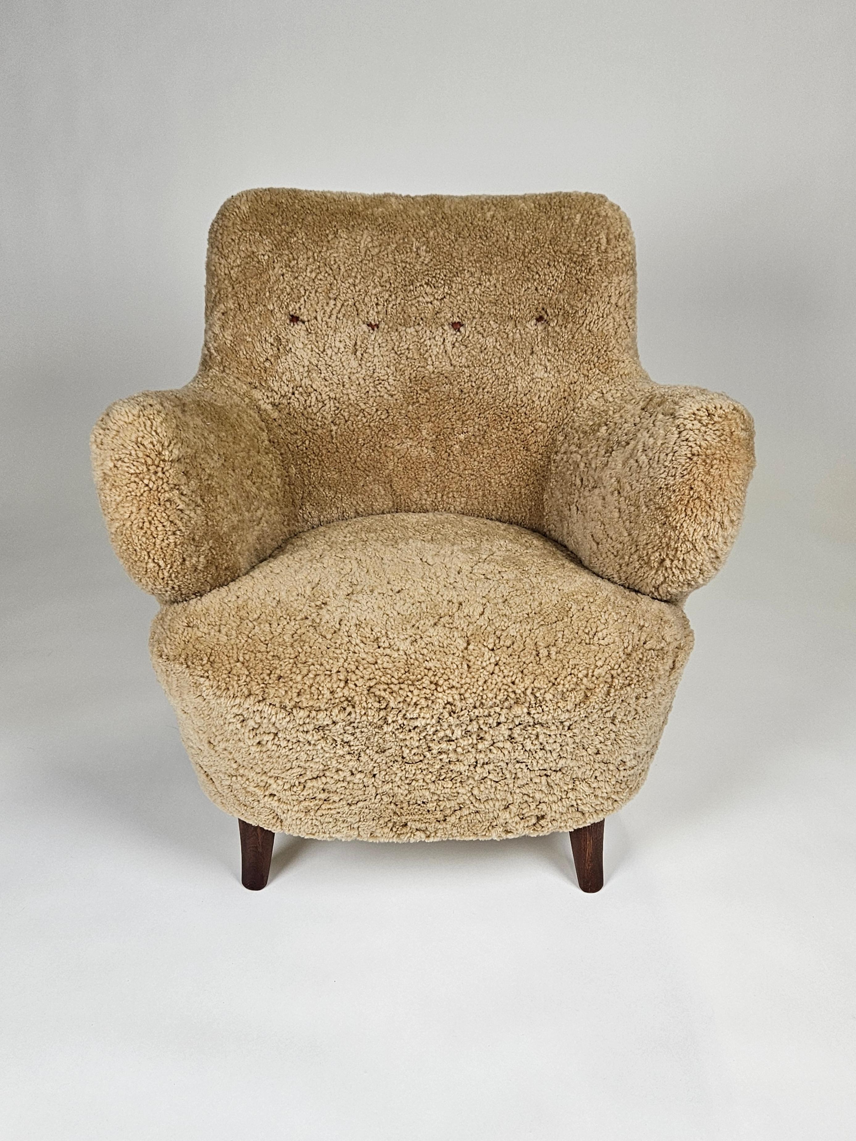 Scandinavian Modern lounge chair designed by Gustav Axel Berg and produced by his own firm AB G.A. Bergs, Sweden, in the 1940s. 

Legs of beech and upholstered in honey colored sheepskin. 

Extremely rare model. 