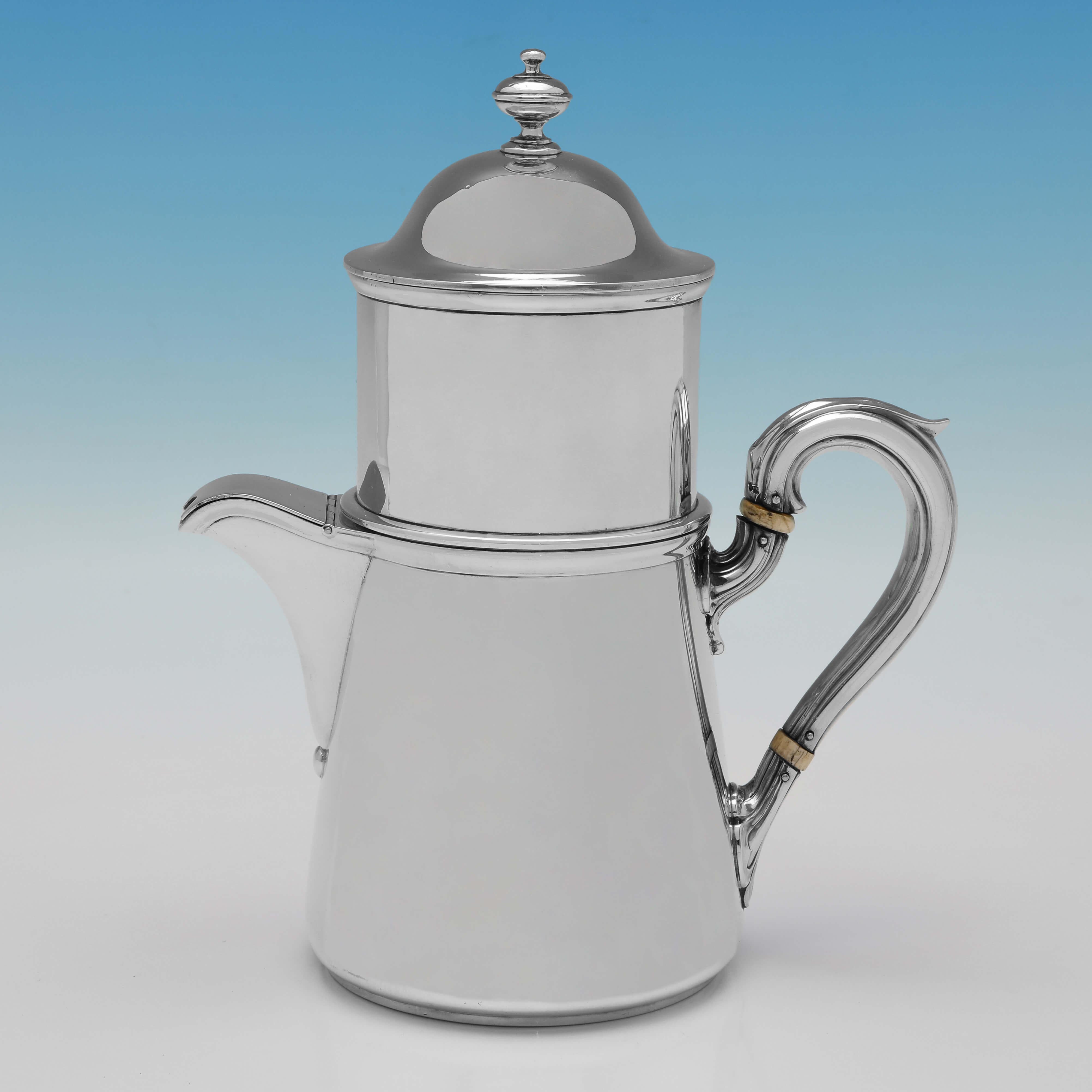 Hallmarked in London in 1862 by Alfred Ivory, this rare, Victorian Antique Sterling Silver Cafetiere, is plain in style, with a scroll handle, and an engraved crest to one side. 

The cafetiere measures 8.25