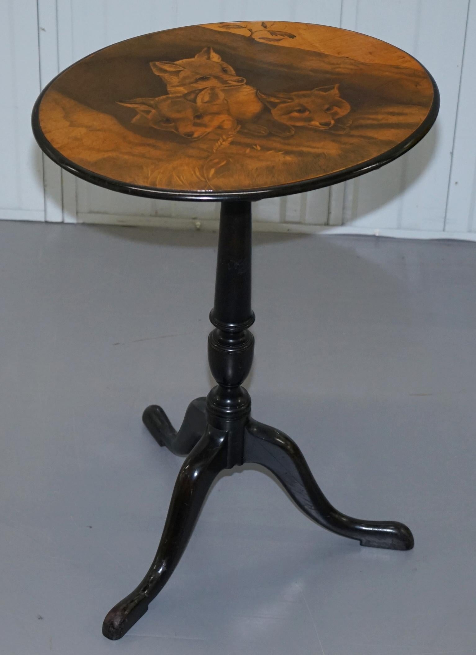 We are delighted to offer for this stunning very rare Victorian tilt top table with pen work drawing of three fox cubs

A very rare piece, I have never seen a penwork table with this level of detail before, the artwork is simply sublime. It
