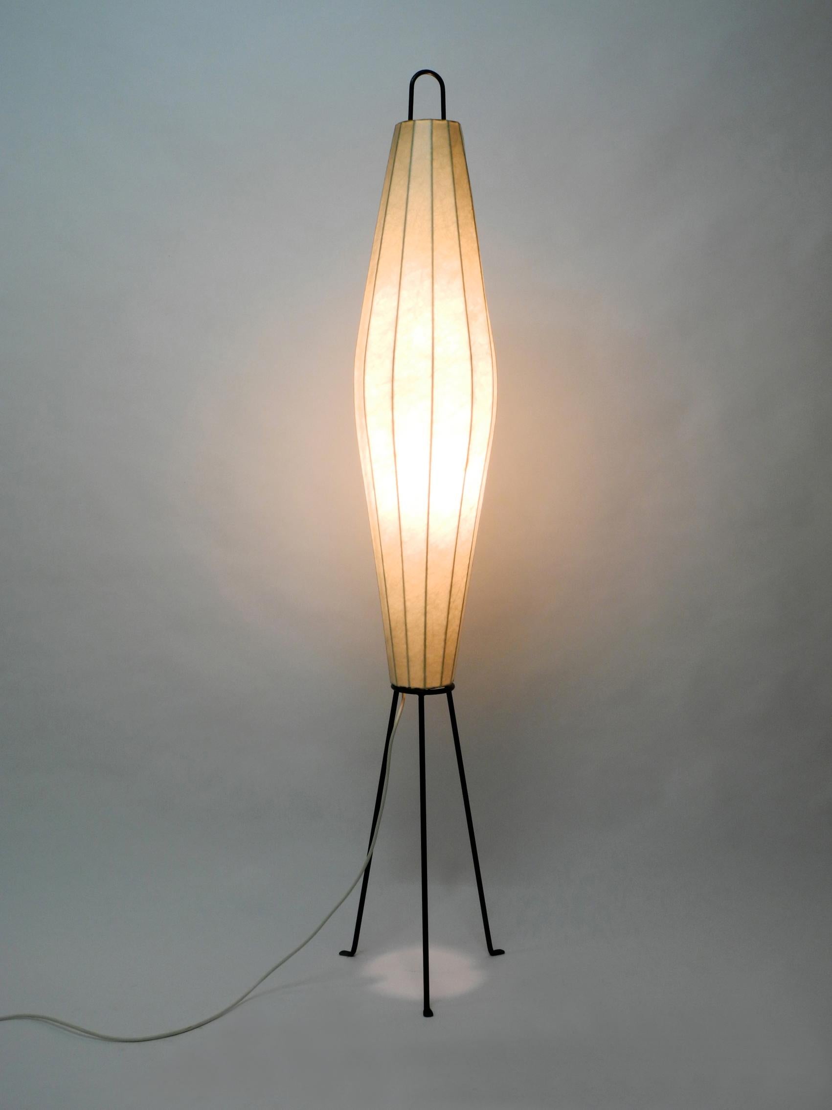 Very rare and huge Mid-Century Modern tripod Cocoon floor lamp. A extra large height of 163 cm. Great minimalistic 1950s design. Very rare in this size. Produces a very pleasant warm light. Very good original vintage condition. The cocoon shade has